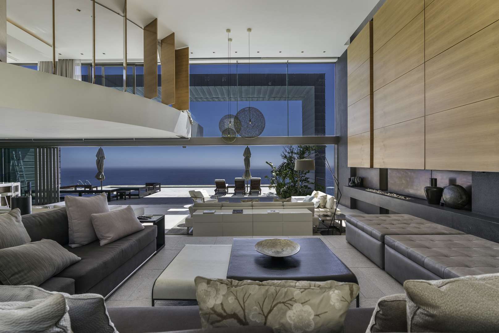 "Spacious luxury villa living area with ocean view in Clifton, Cape Town mansion for sale.",Luxury living room with ocean view in Clifton, Cape Town mansion for sale
