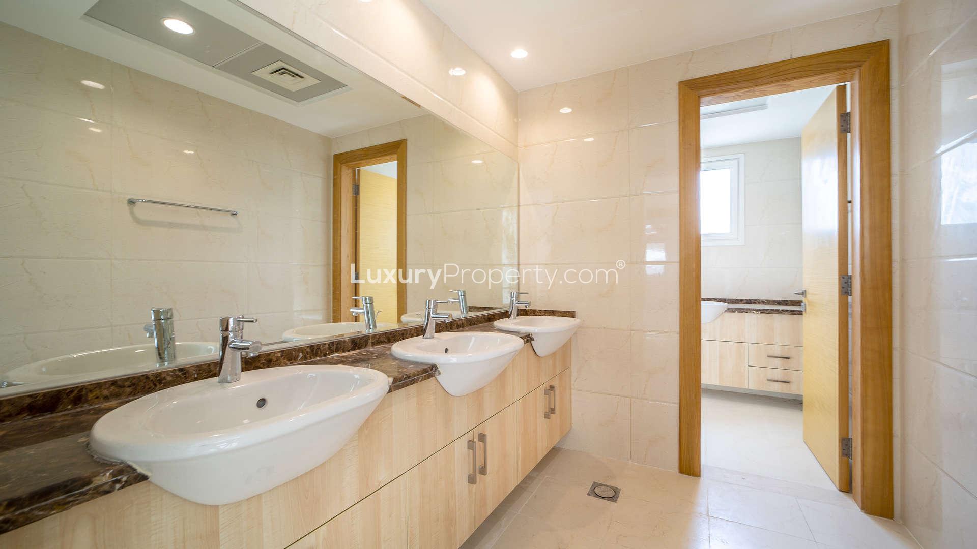"Spacious bathroom with double sinks in 5-bedroom villa, The Sustainable City, Dubailand.",Spacious living area in 5-bedroom villa, The Sustainable City, Dubailand, marble flooring