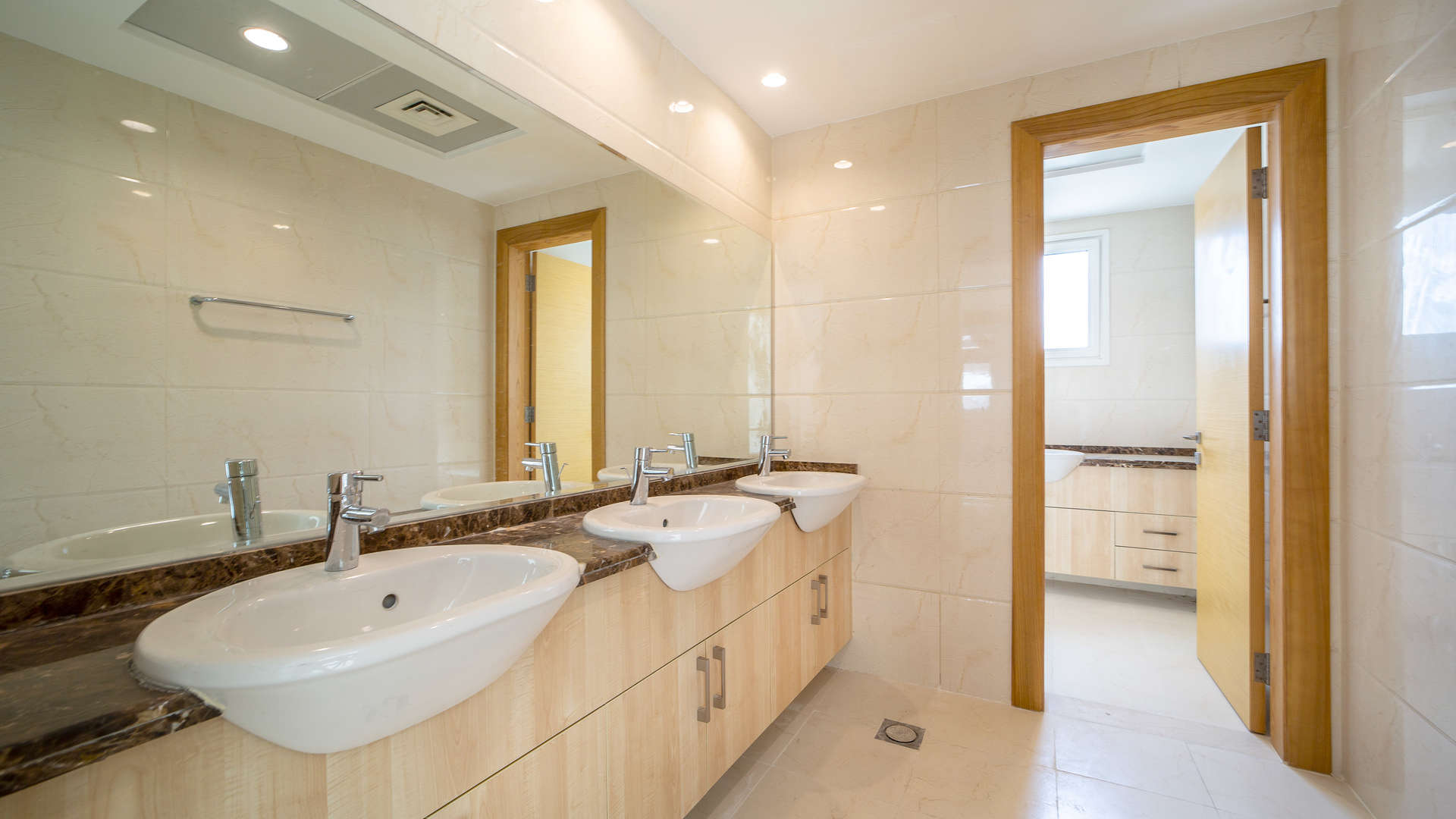 "Spacious bathroom with double sinks in 5-bedroom villa, The Sustainable City, Dubailand.",Spacious living area in 5-bedroom villa, The Sustainable City, Dubailand, marble flooring