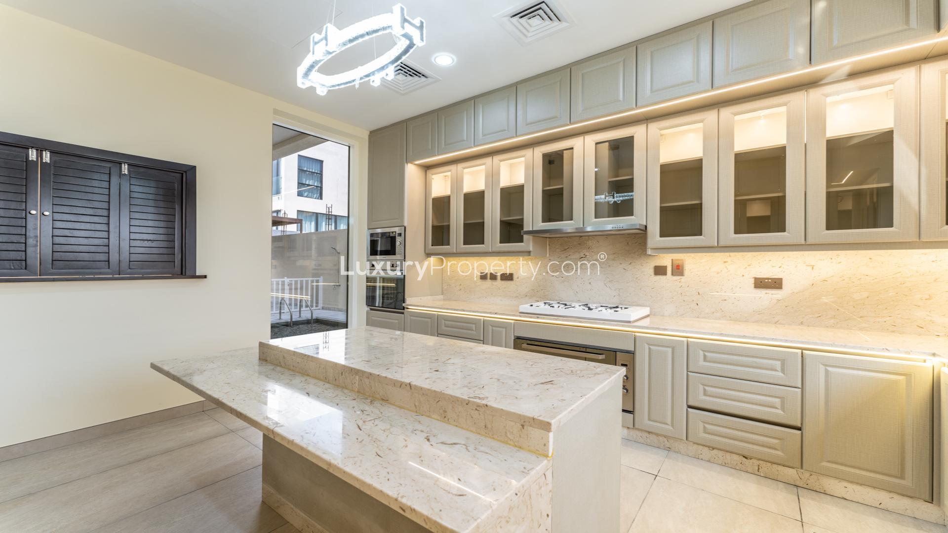 Luxurious kitchen in Nad Al Sheba 1 villa, marble countertops and modern cabinetry