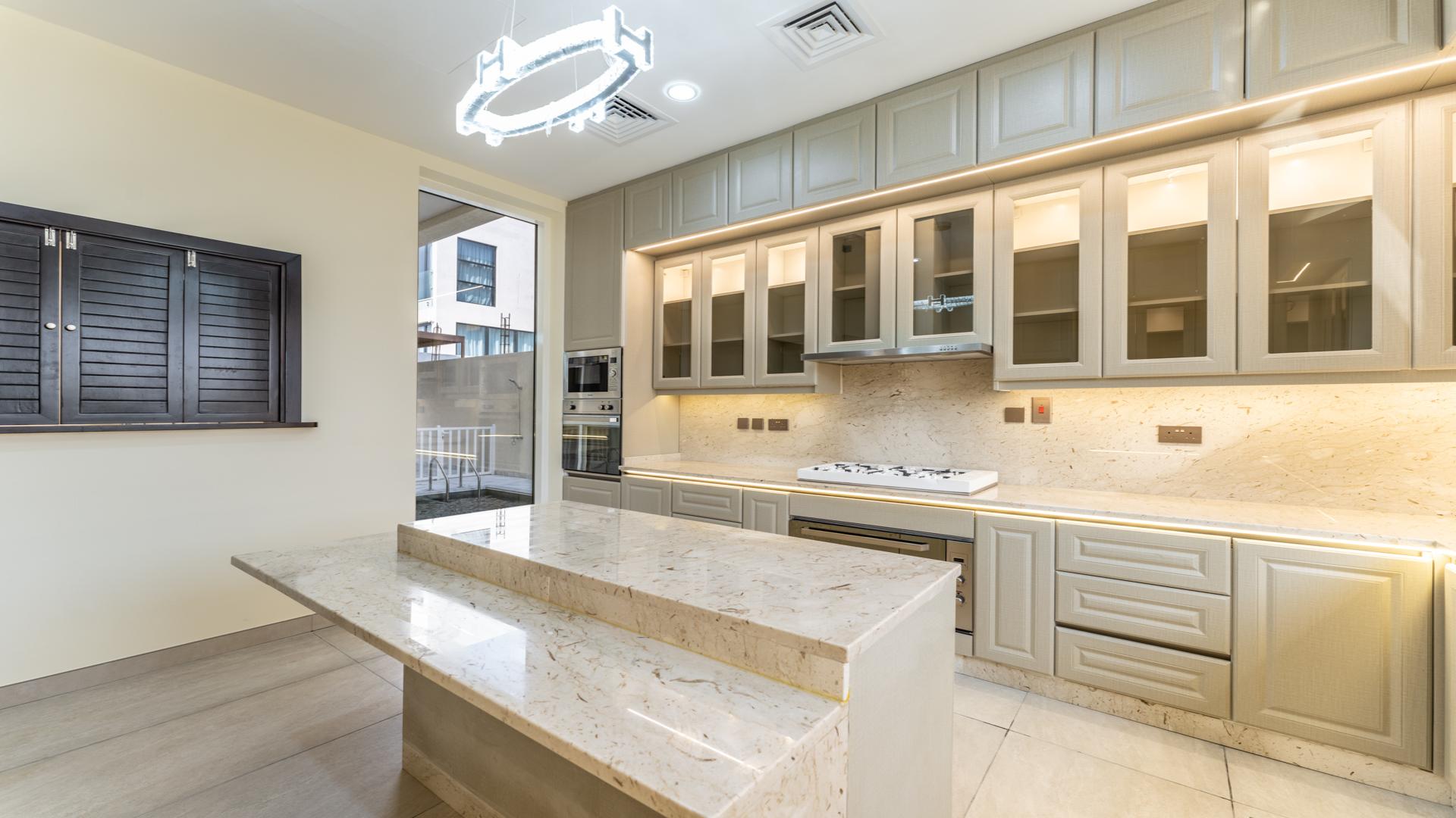 Luxurious kitchen in Nad Al Sheba 1 villa, marble countertops and modern cabinetry