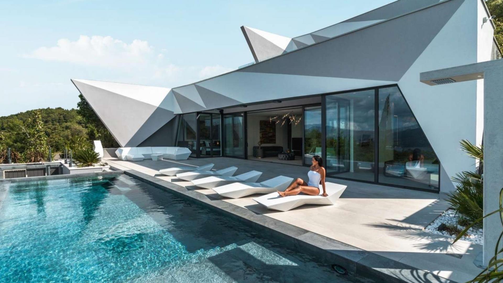 Elegant contemporary villa patio with pool in Korcula, Croatia at dusk