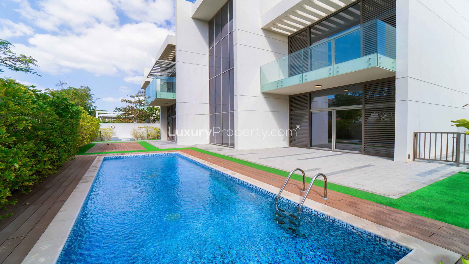 Contemporary villa spacious living room with marble floors and garden view in District One
