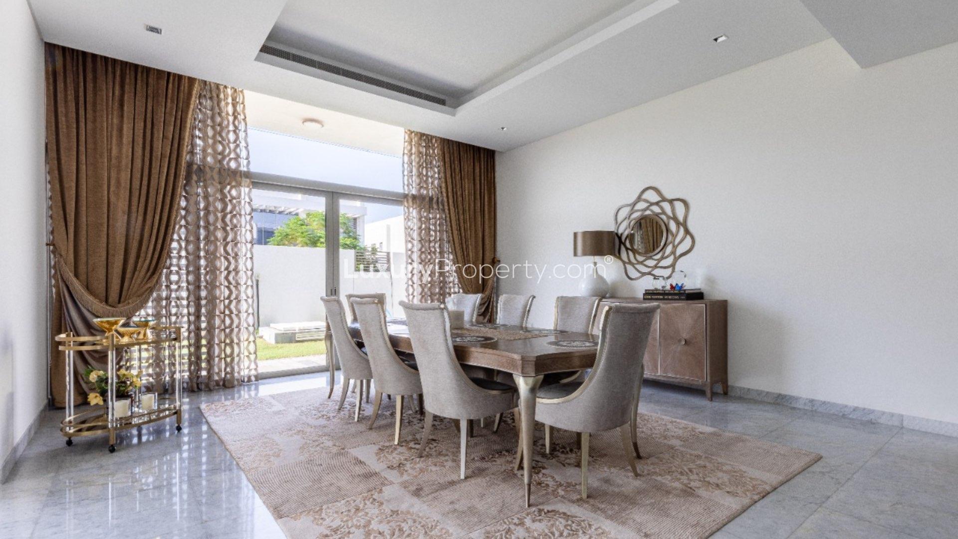 Luxurious villa pool in District One, MBR City, surrounded by lush greenery