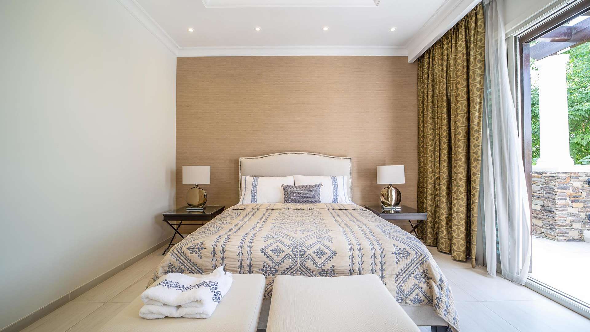 "Elegant bedroom in luxury villa, District One, Mohammed Bin Rashid City, for sale.","Elegant dining room in luxury villa, District One, Mohammed Bin Rashid City, for sale.","Stunning luxury villa exterior in District One, Mohammed Bin Rashid City, surrounded by lush greenery.",Luxurious bathroom in District One villa, featuring elegant vanity and glass shower enclosure