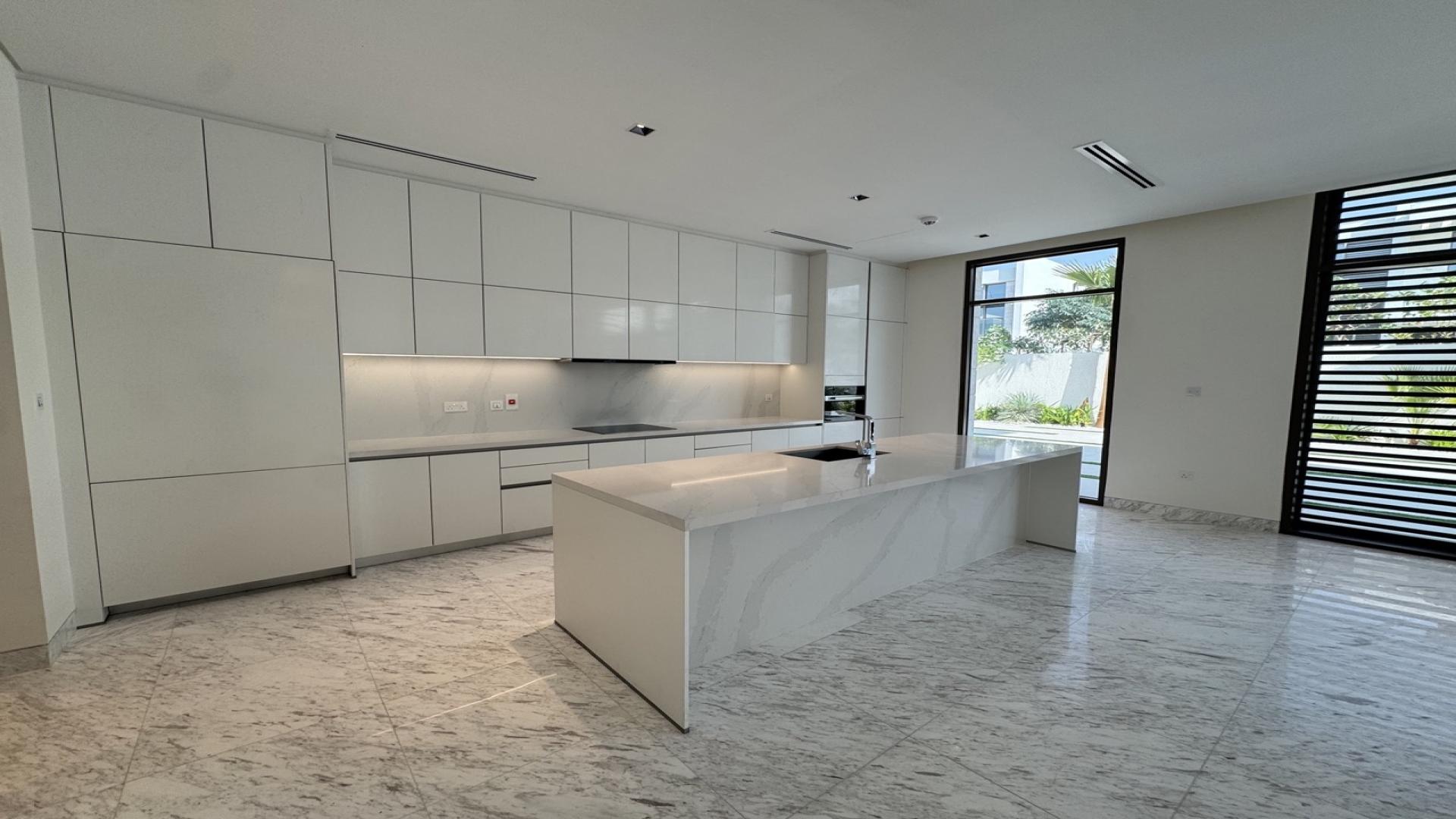 Modern kitchen in 5-bedroom villa, District One, MBR City, Dubai. Spacious design, marble flooring