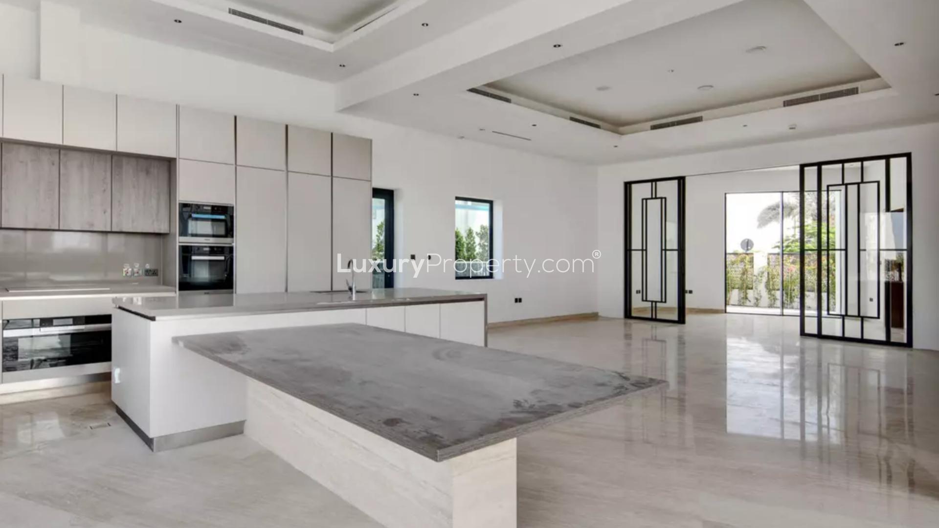 Modern kitchen with pool view in 5-bedroom villa, Parkway Vistas, Dubai Hills Estate