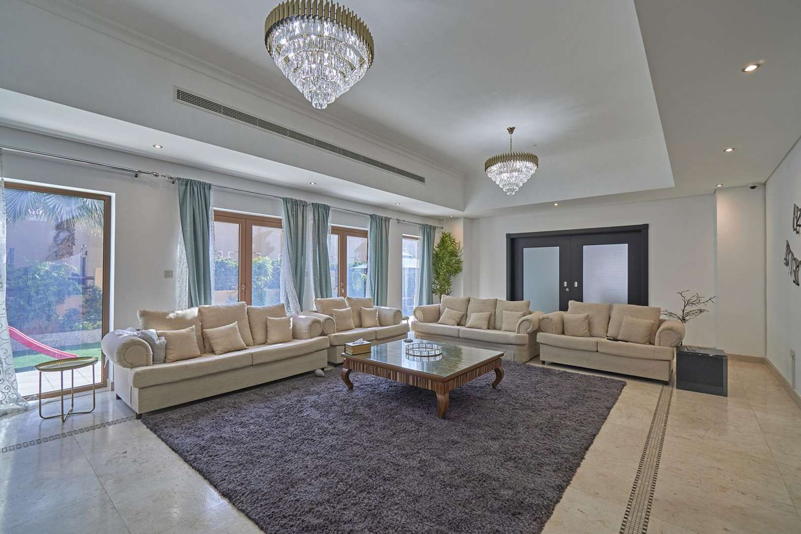 Luxurious living room in 5-bedroom villa, Al Furjan North Village, Dubai, with elegant decor