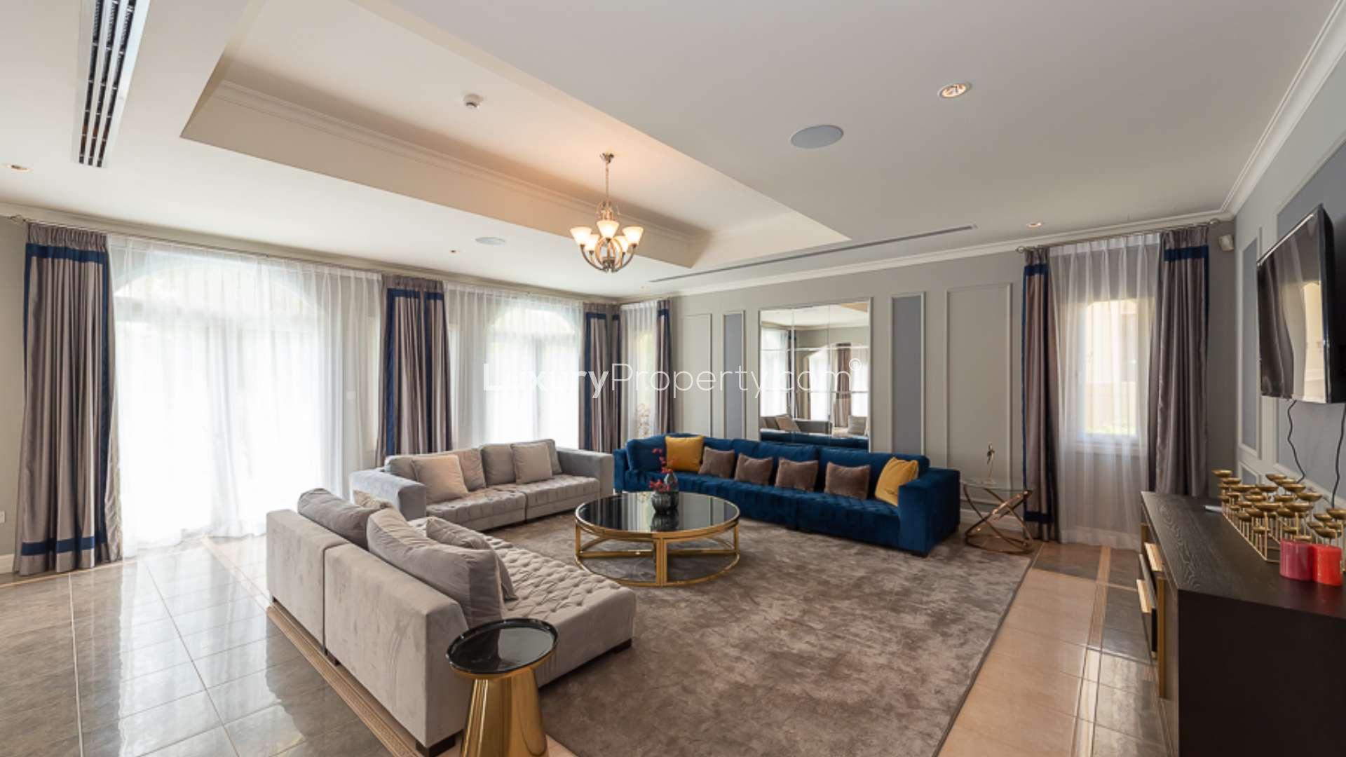 Luxurious living room in Jumeirah Golf Estates villa, featuring elegant decor and ample seating
