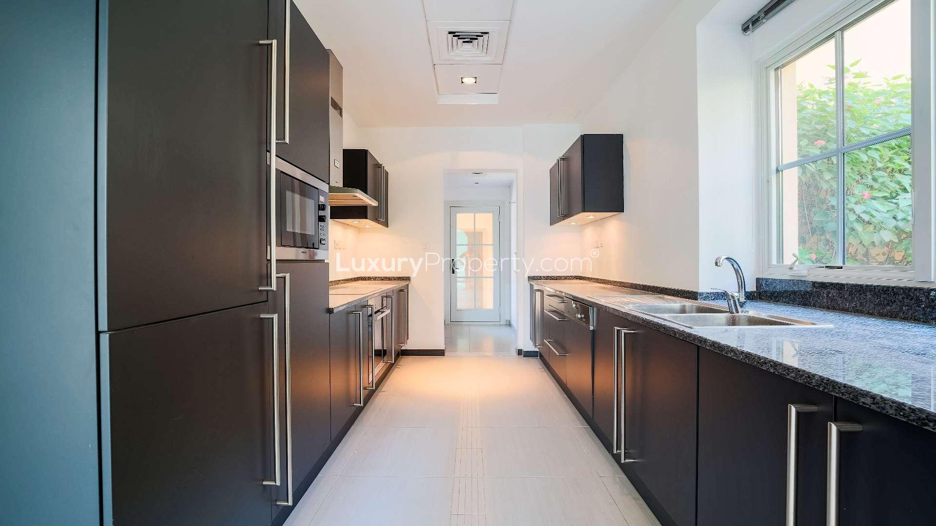 Spacious villa interior with large windows and tiled floors in Jumeirah Golf Estates, Earth