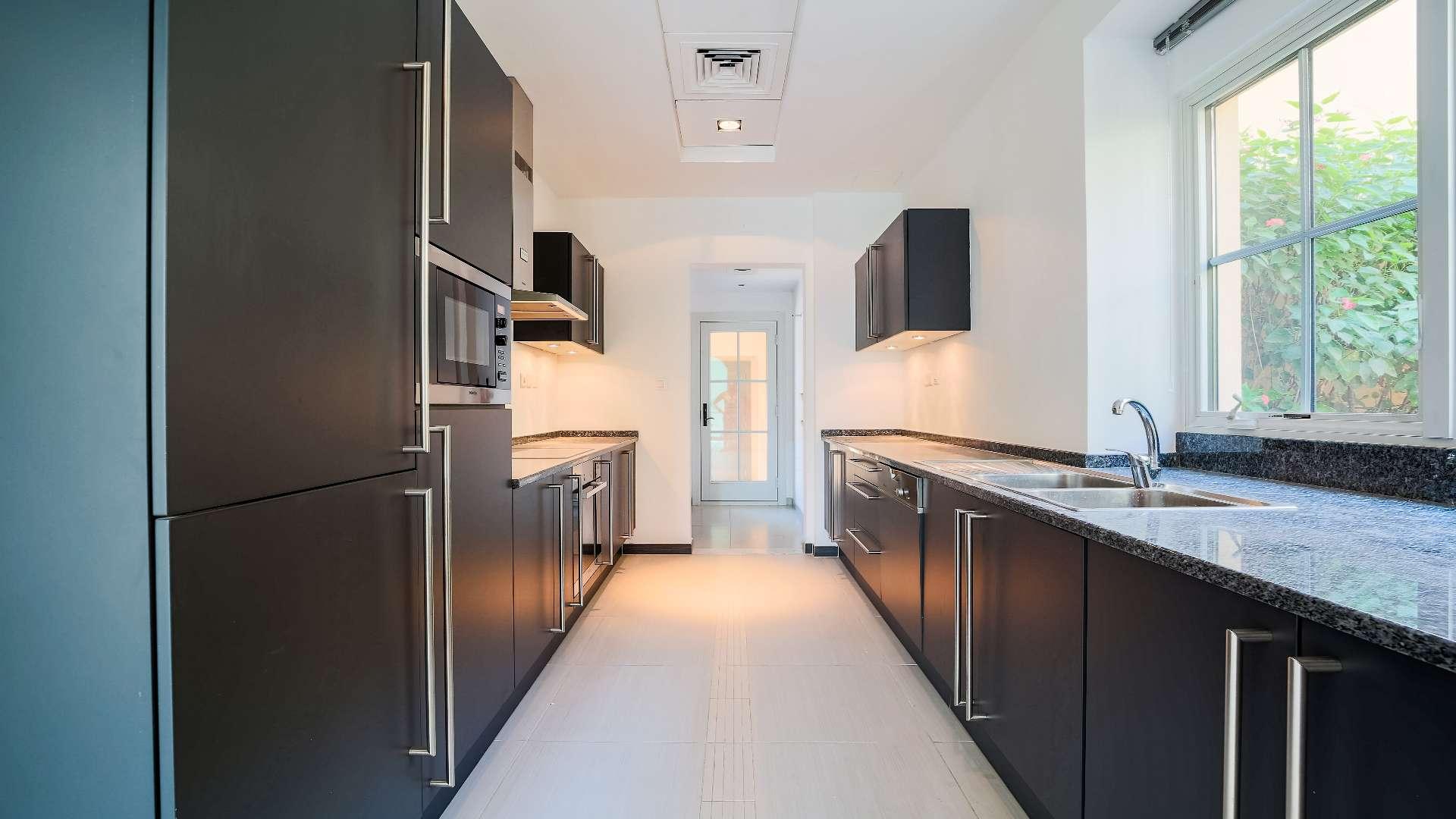 Spacious villa interior with large windows and tiled floors in Jumeirah Golf Estates, Earth