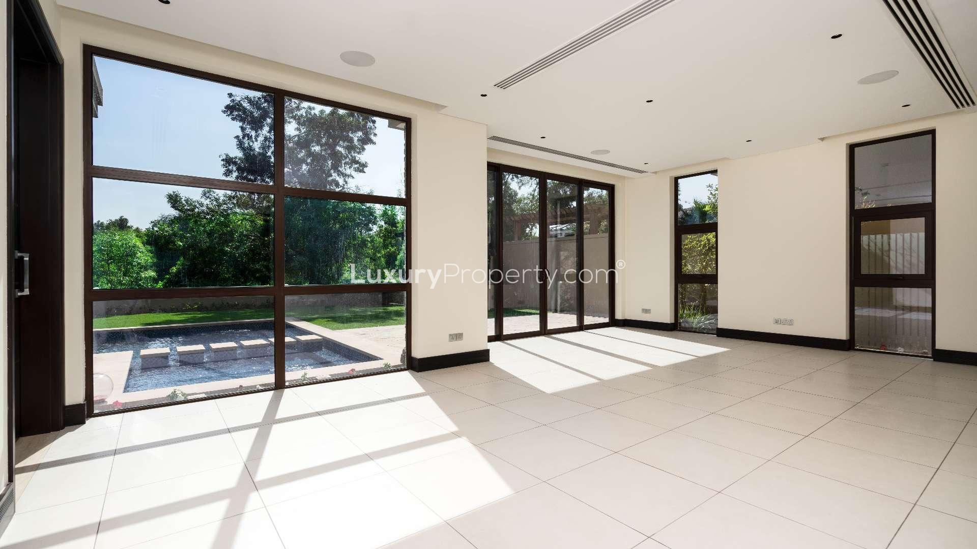 Spacious villa interior with large windows and garden view in Jumeirah Golf Estates
