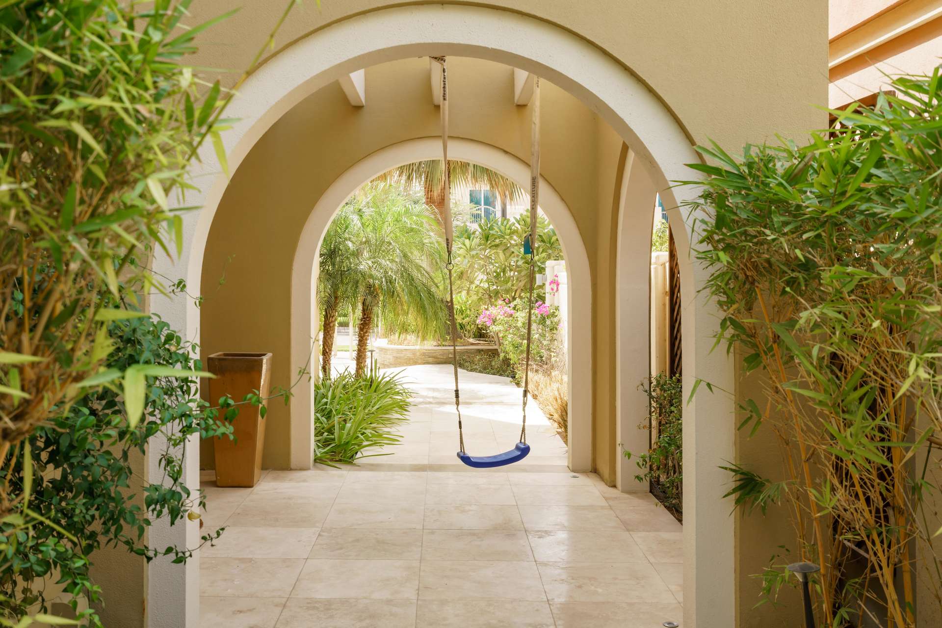 Bright bedroom with wooden floors and balcony in Victory Heights villa, Dubai Sports City