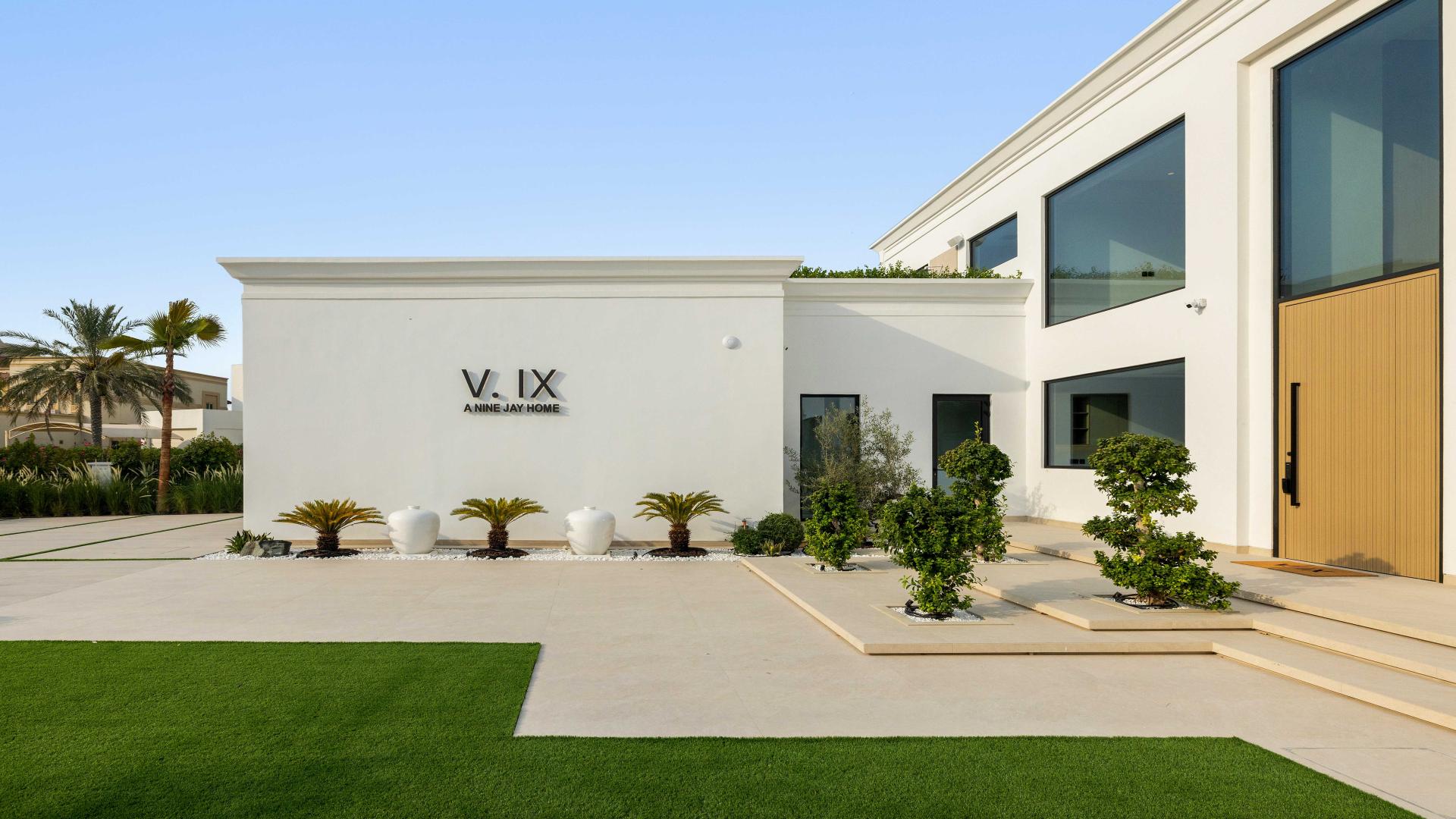 Luxurious living room in Vastu-compliant villa, Jumeirah Islands, with pool and garden view