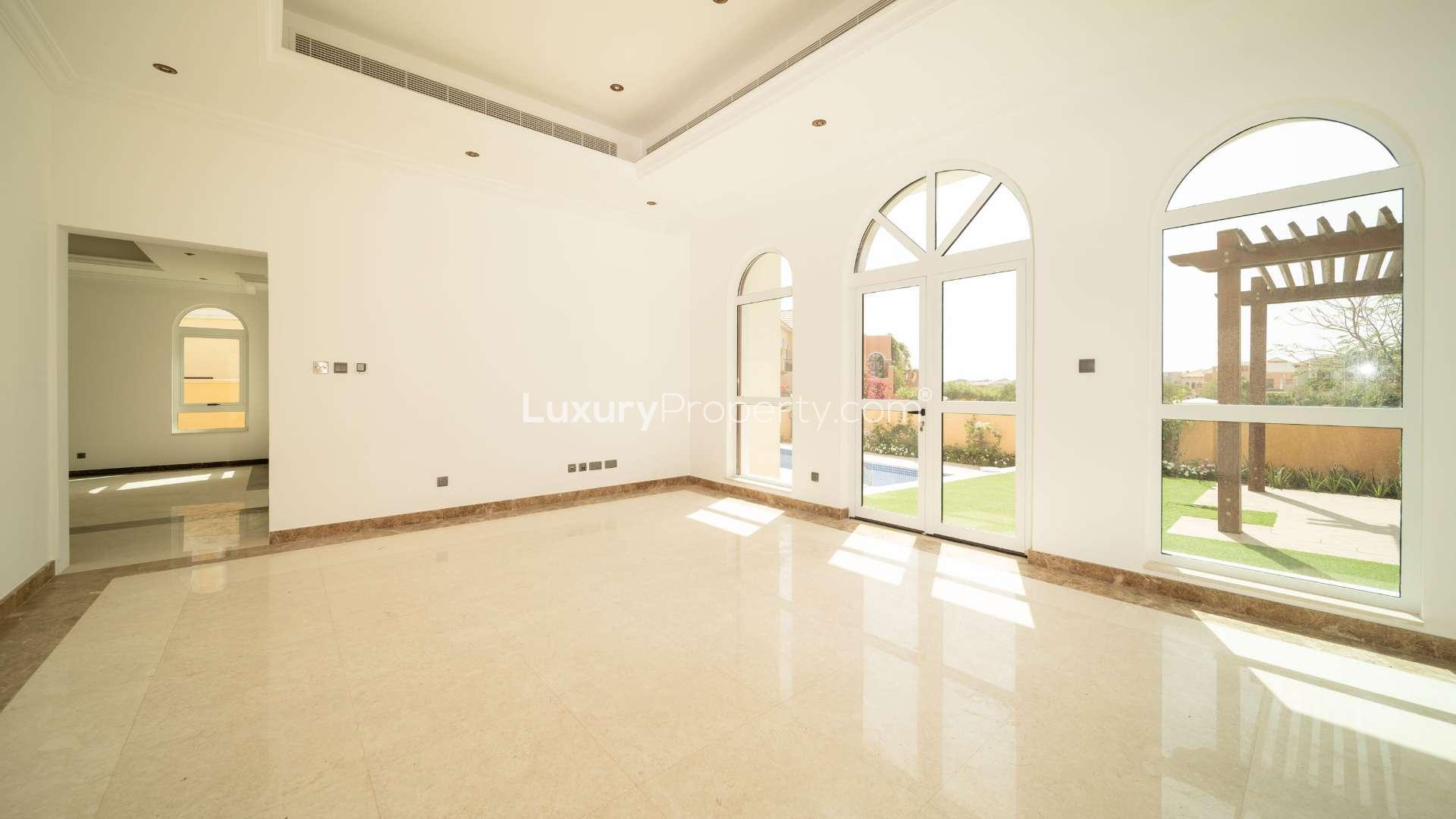 Tuscan-style villa with arched windows and manicured lawn, Jumeirah Golf Estates, Fire community
