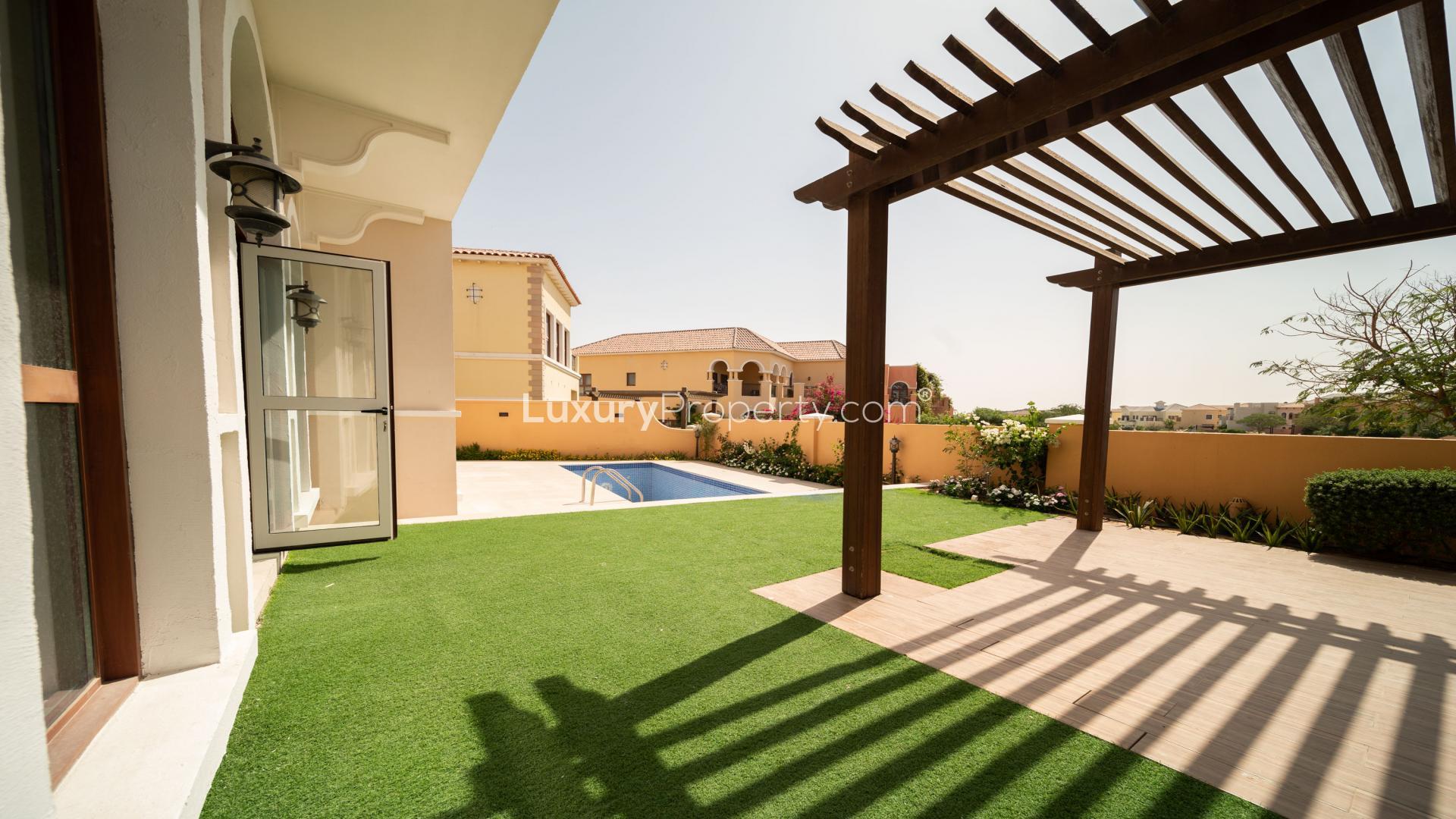 Bright living room with arched windows in Tuscan-style villa, Jumeirah Golf Estates, for sale