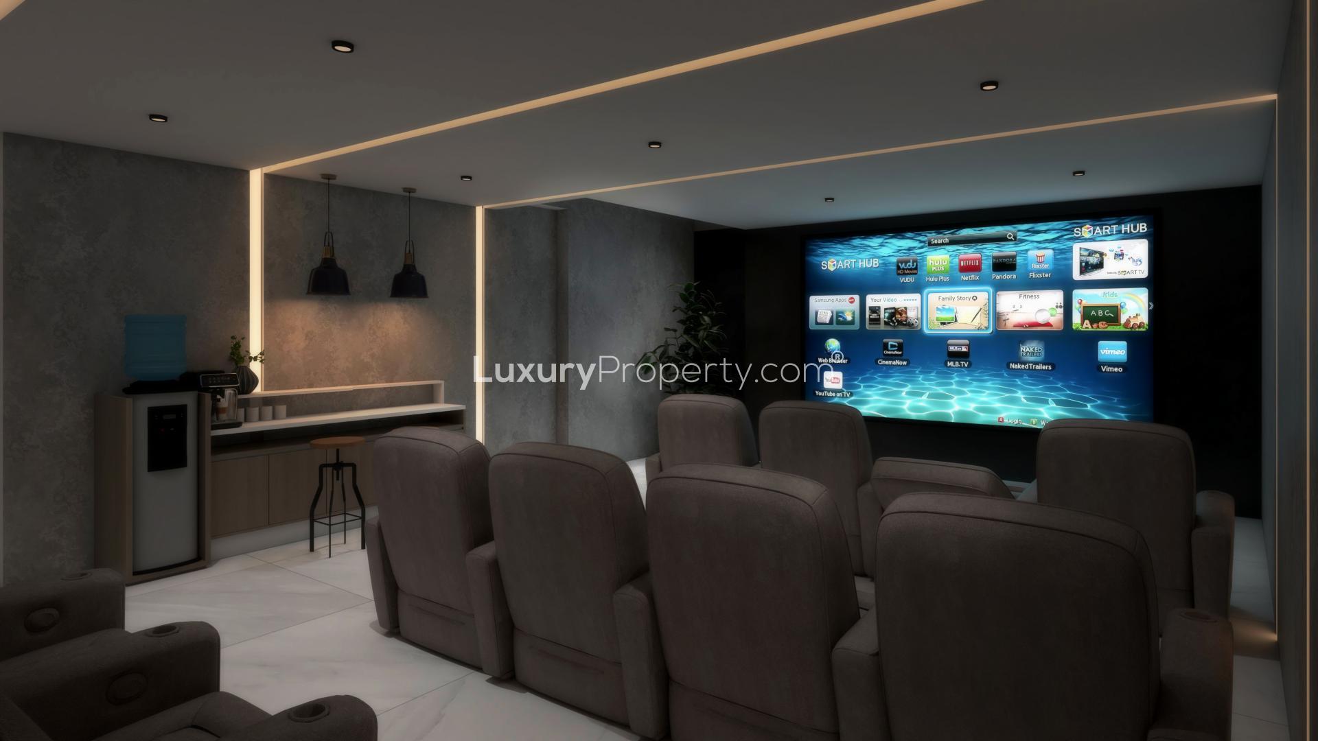 Luxurious living room with large windows, modern decor, and outdoor views in Sienna Lakes villa