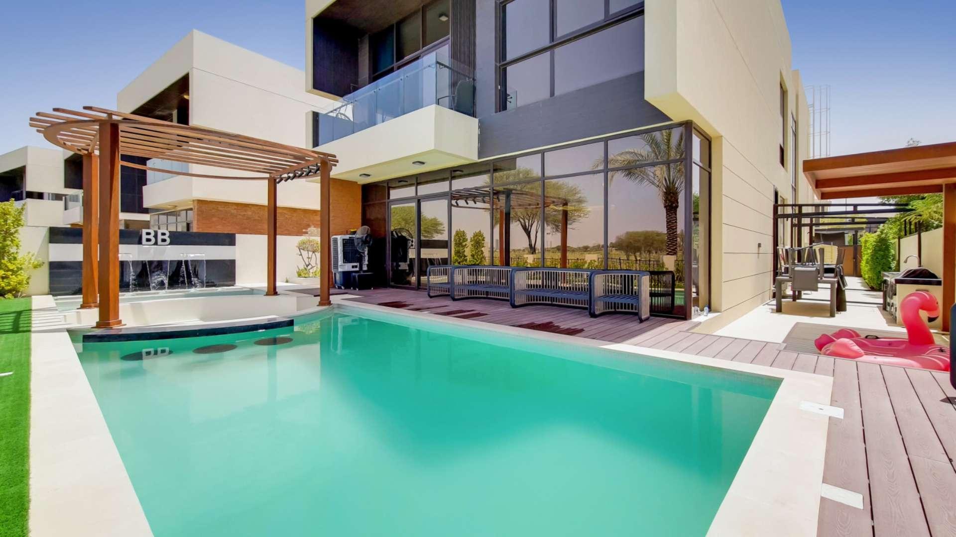Upgraded 5-bedroom villa exterior with lush garden in Flora, Damac Hills