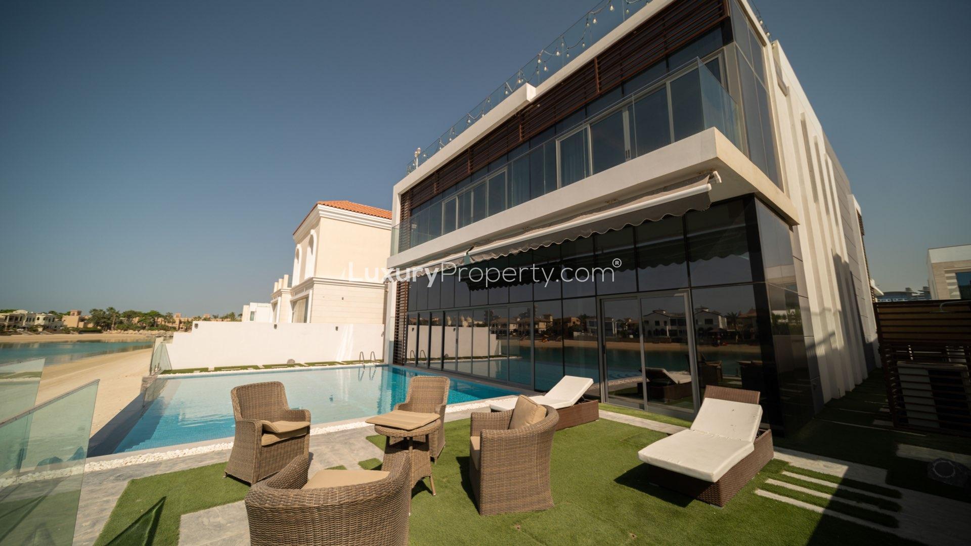 Luxurious villa interior with modern design, large windows, and elegant staircase in Palm Jumeirah
