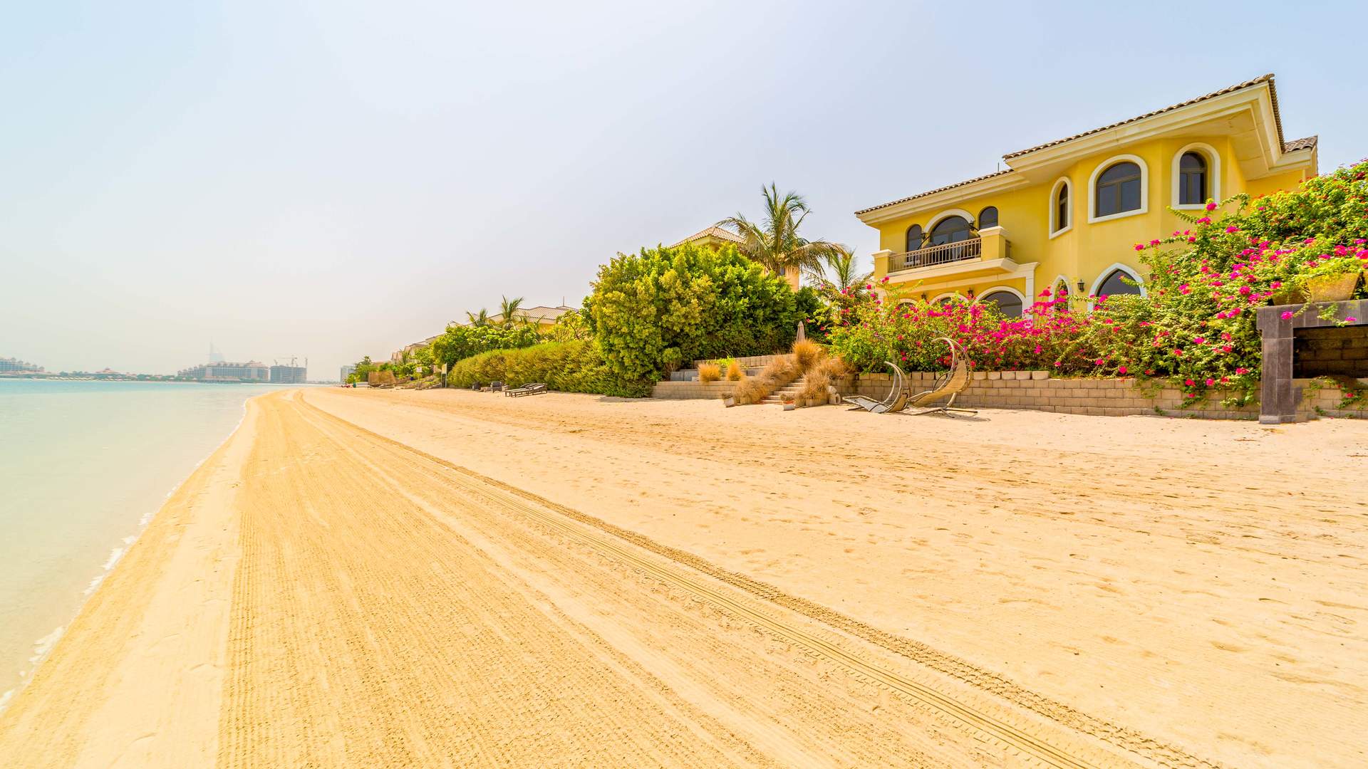 Five-bedroom Palm Jumeirah villa exterior with garden and palm trees, for sale