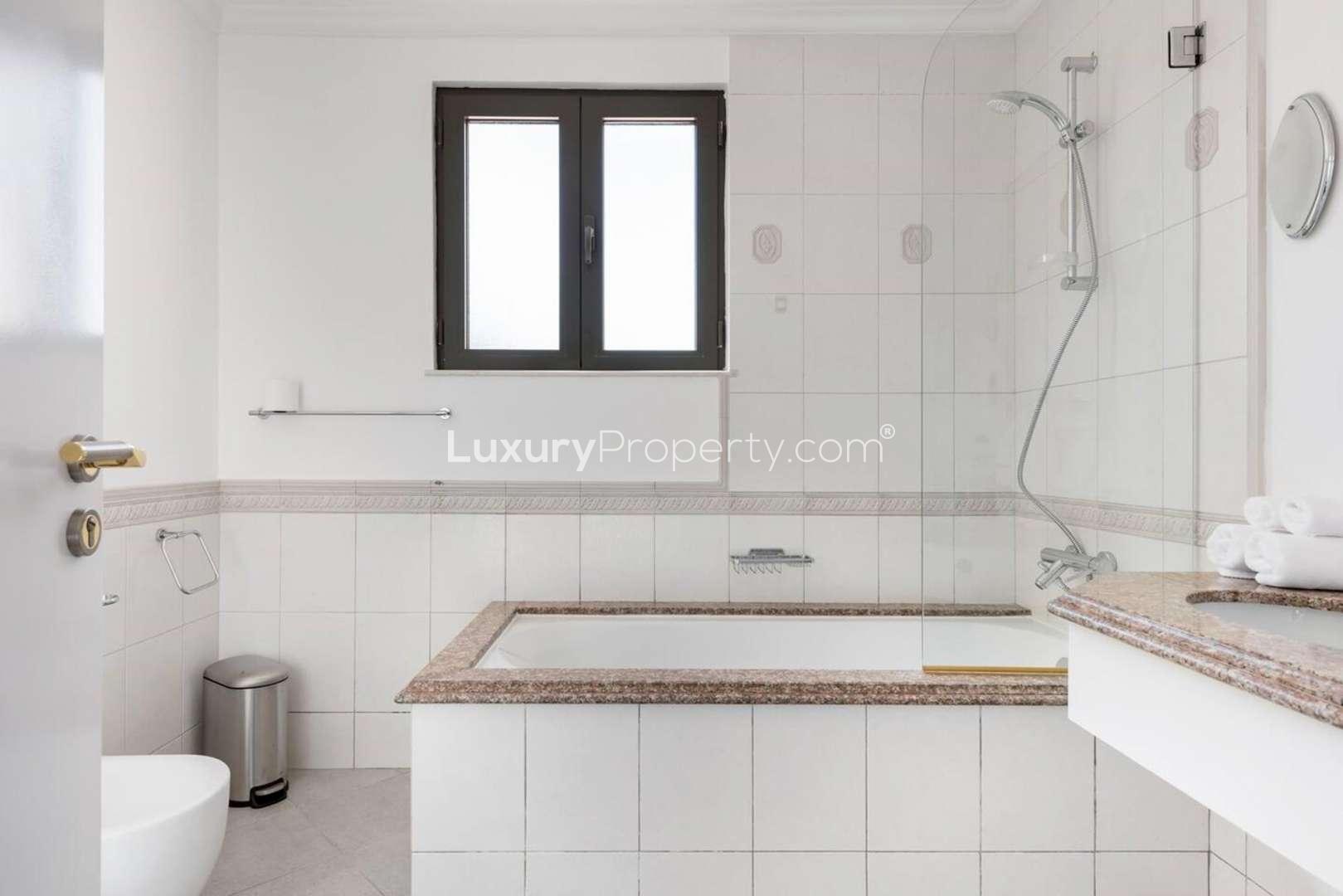 Palm Jumeirah Garden Homes villa exterior with palm trees, double garage, and landscaped driveway