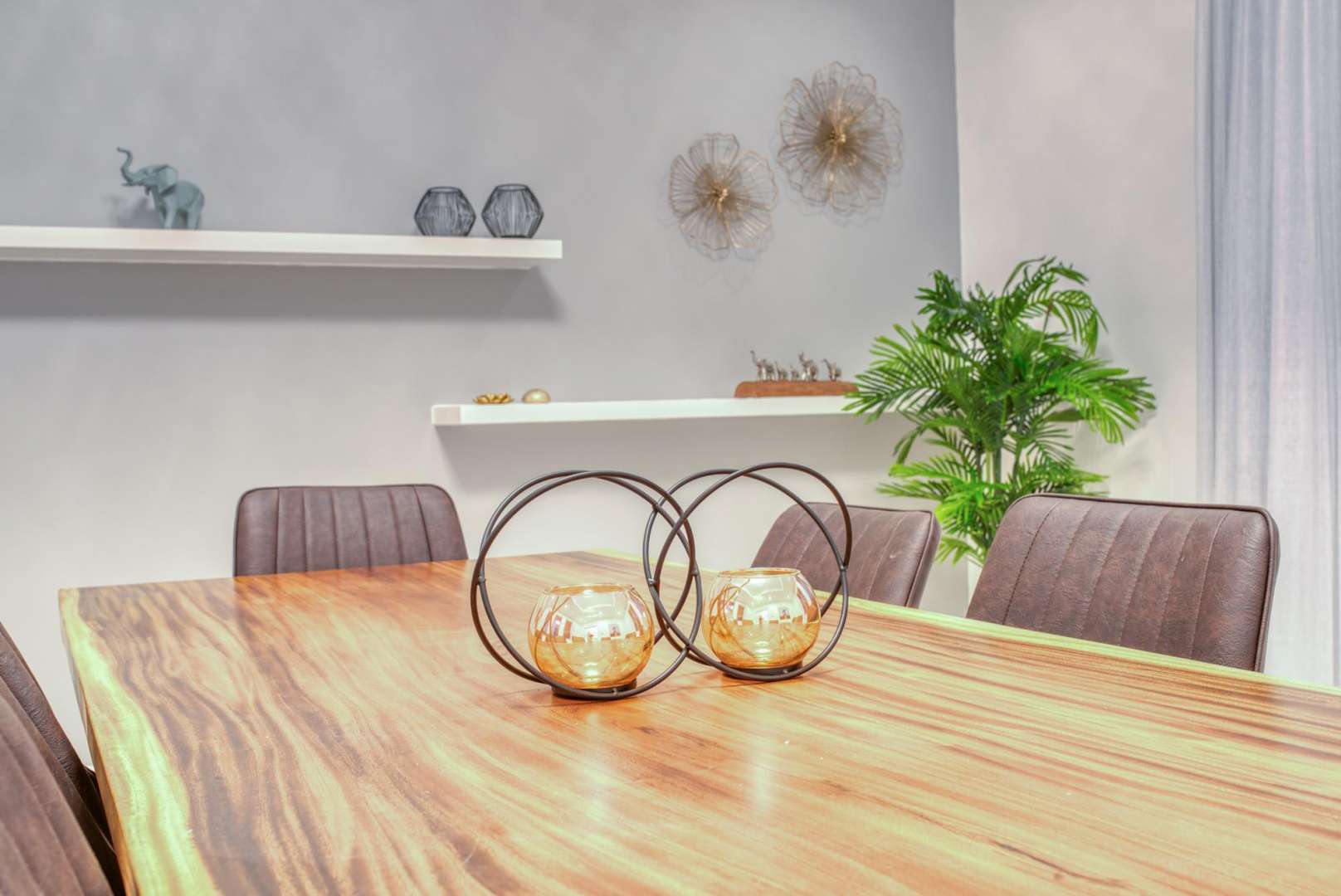 "Spacious villa interior with beach view on Palm Jumeirah, available for rent.",Dining area in luxury Palm Jumeirah villa with elegant decor and wooden table