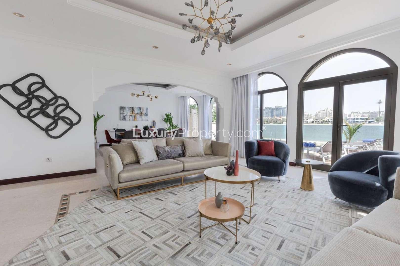 Luxurious living room in Palm Jumeirah villa with waterfront view and modern decor