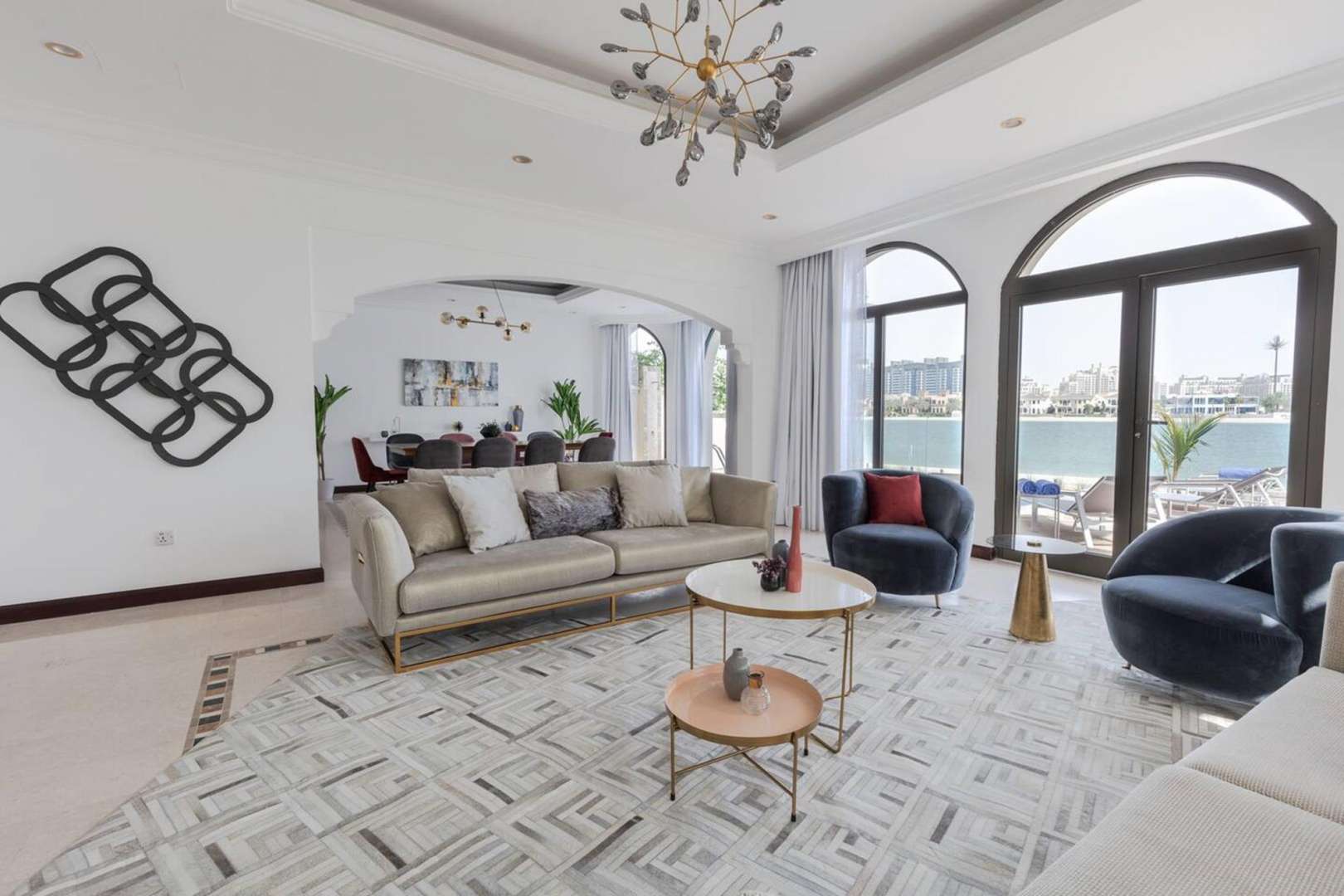 Luxurious living room in Palm Jumeirah villa with waterfront view and modern decor