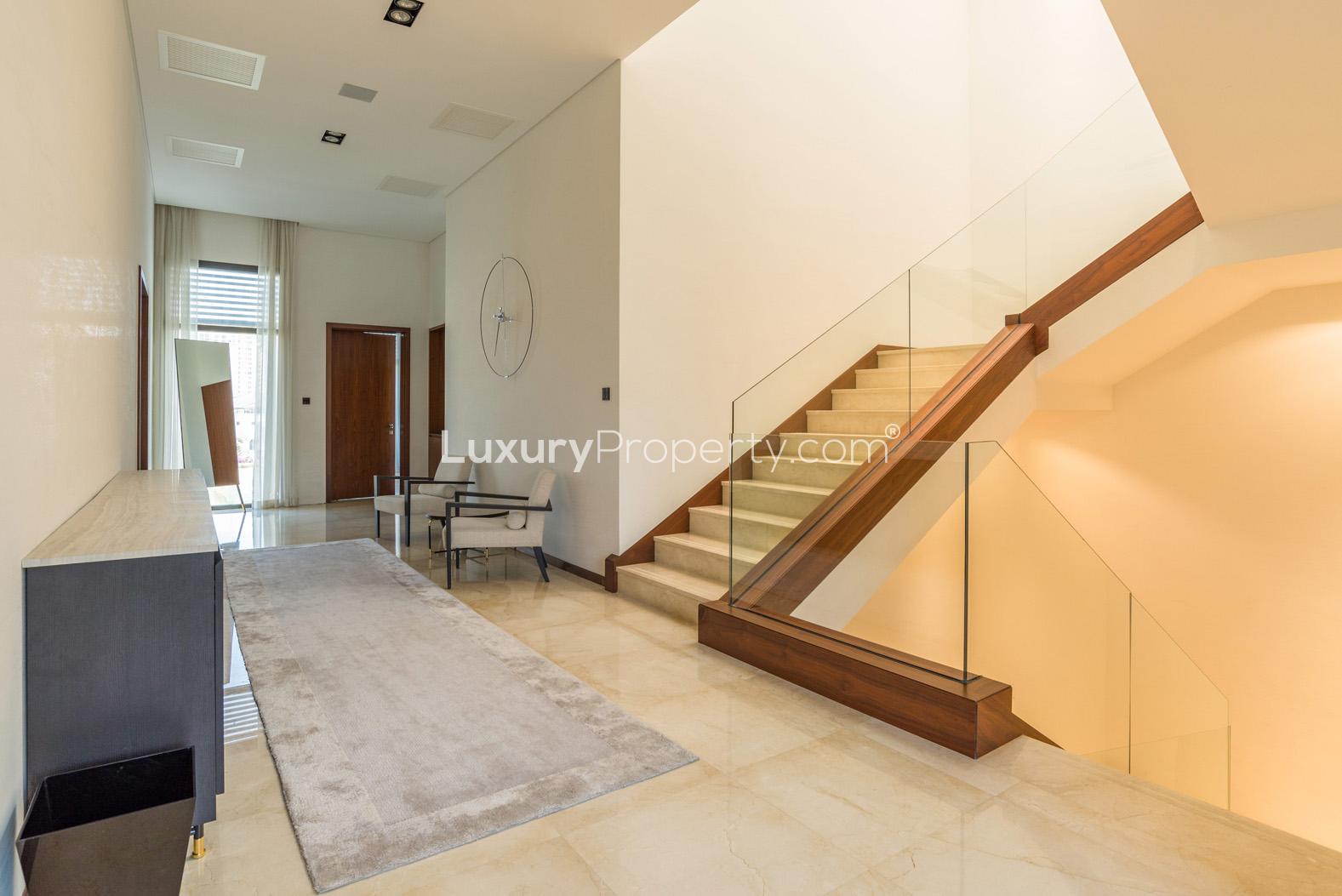 "Luxury villa gym with equipment, Palm Jumeirah, Frond N, 4-bed, Garden Homes, for sale.",Elegant interior of luxury villa with modern staircase and stylish decor, Palm Jumeirah
