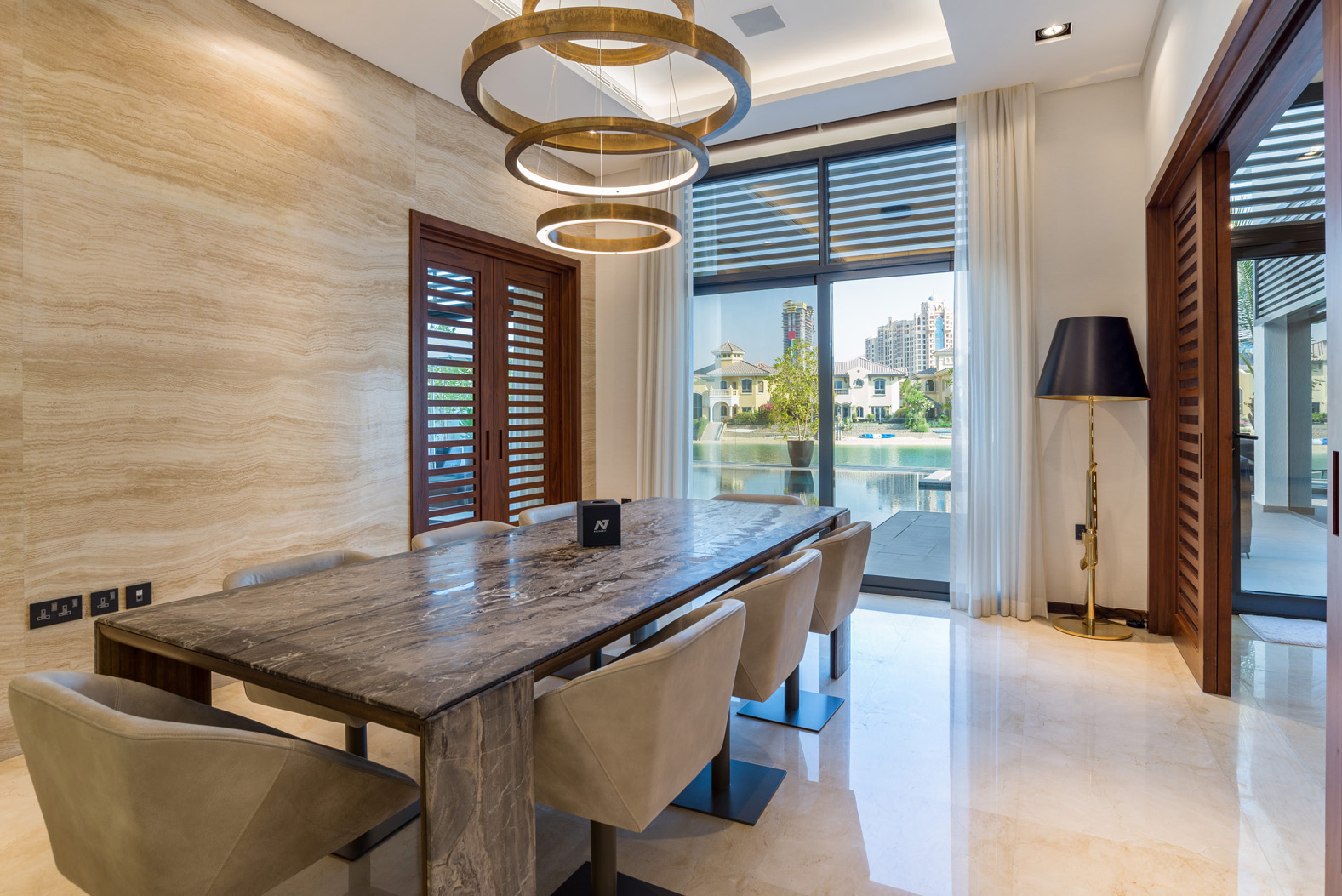 Modern dining room in luxury villa, Palm Jumeirah, overlooking pool and garden view