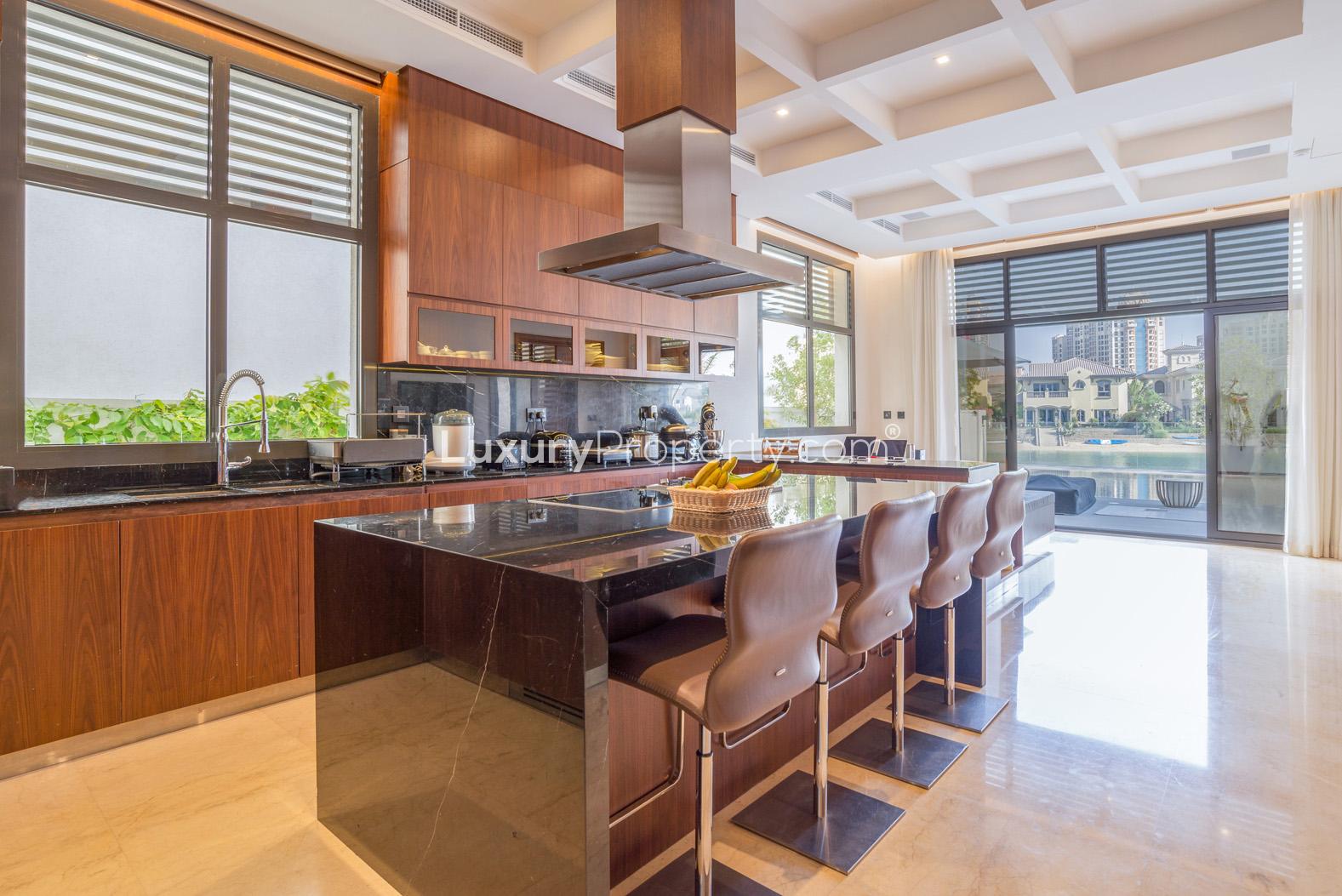 Modern kitchen in luxury villa, Palm Jumeirah, featuring island seating and waterfront views