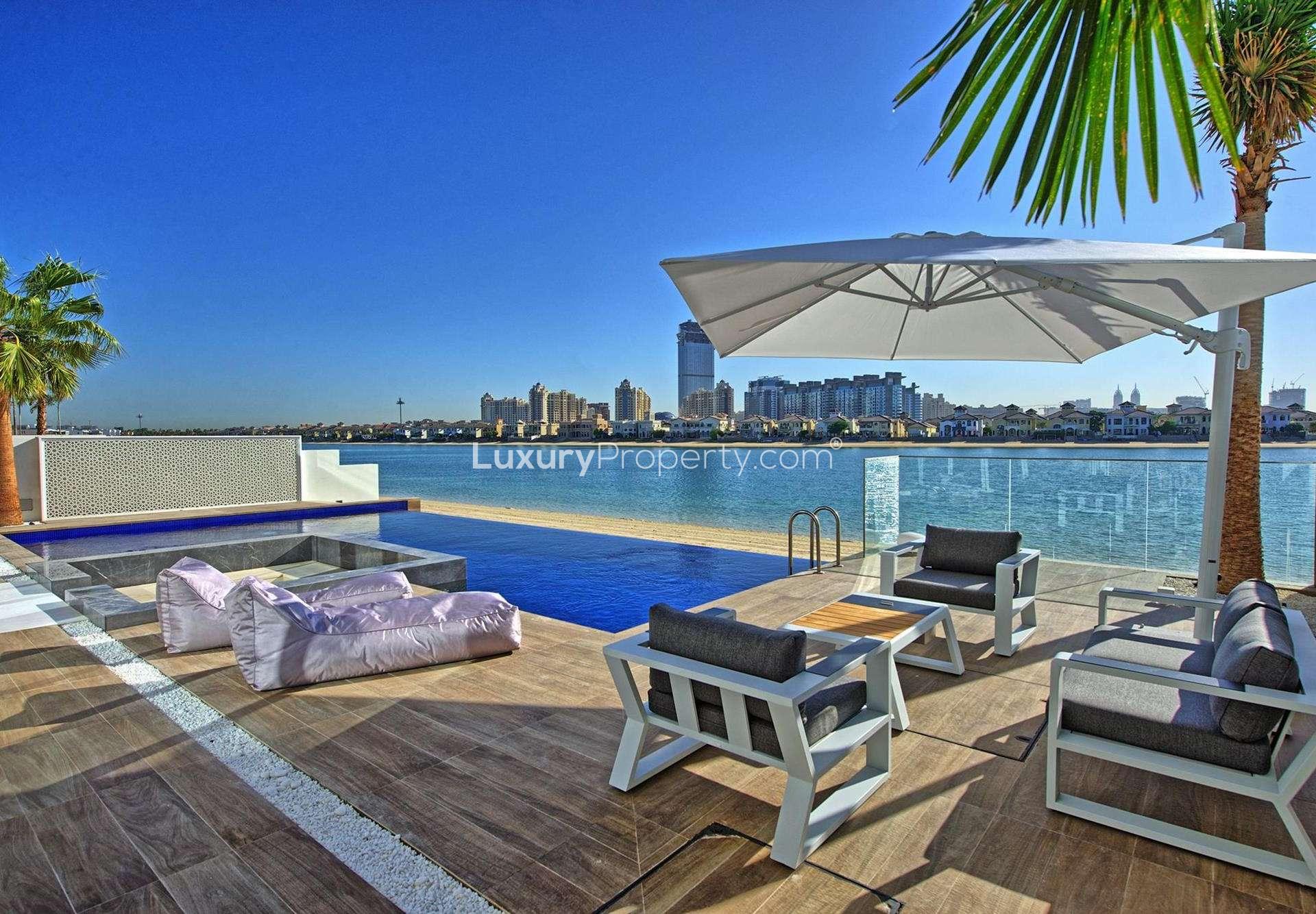Luxurious open-plan living area with waterfront views in Palm Jumeirah villa for sale