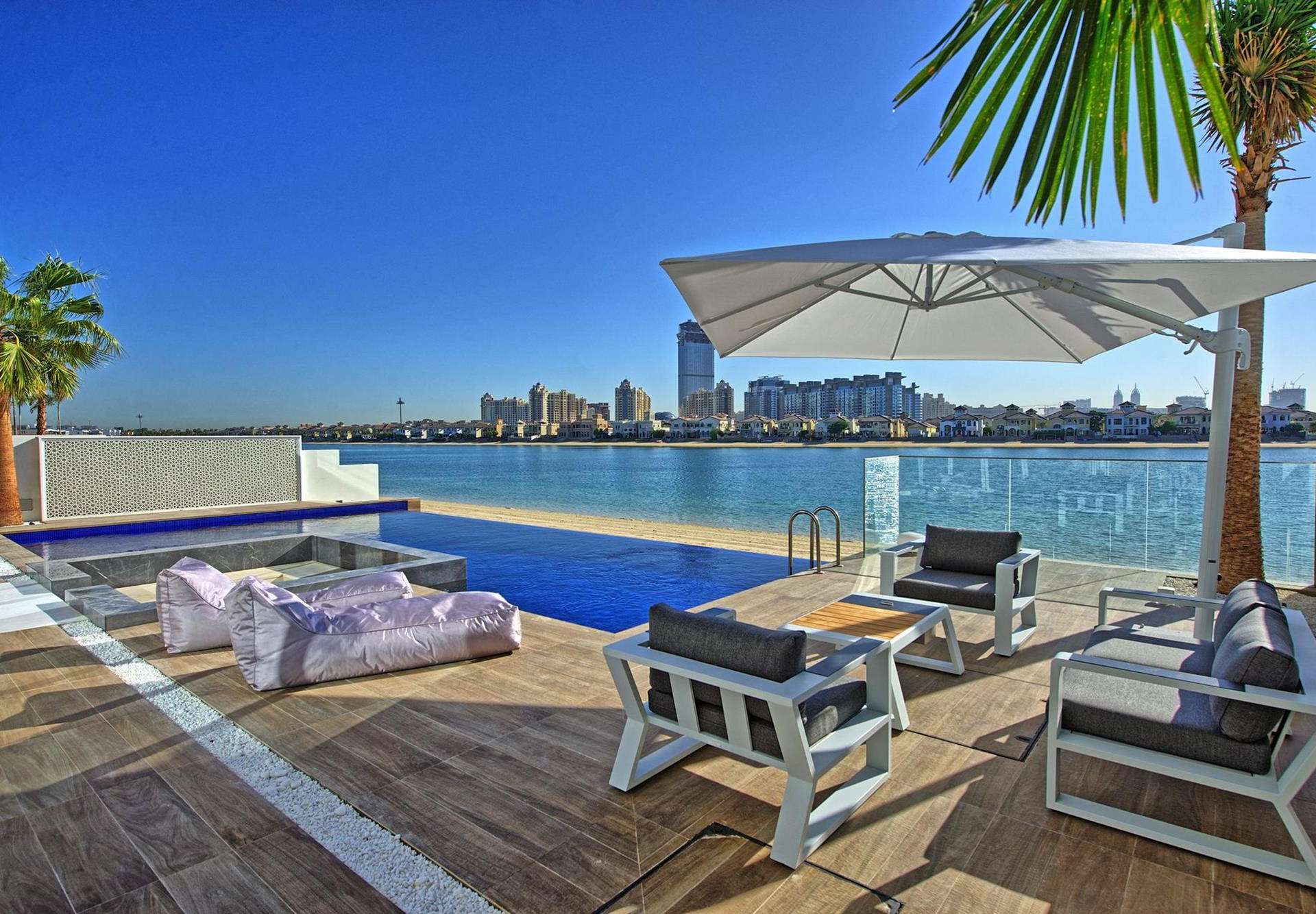 Luxurious open-plan living area with waterfront views in Palm Jumeirah villa for sale