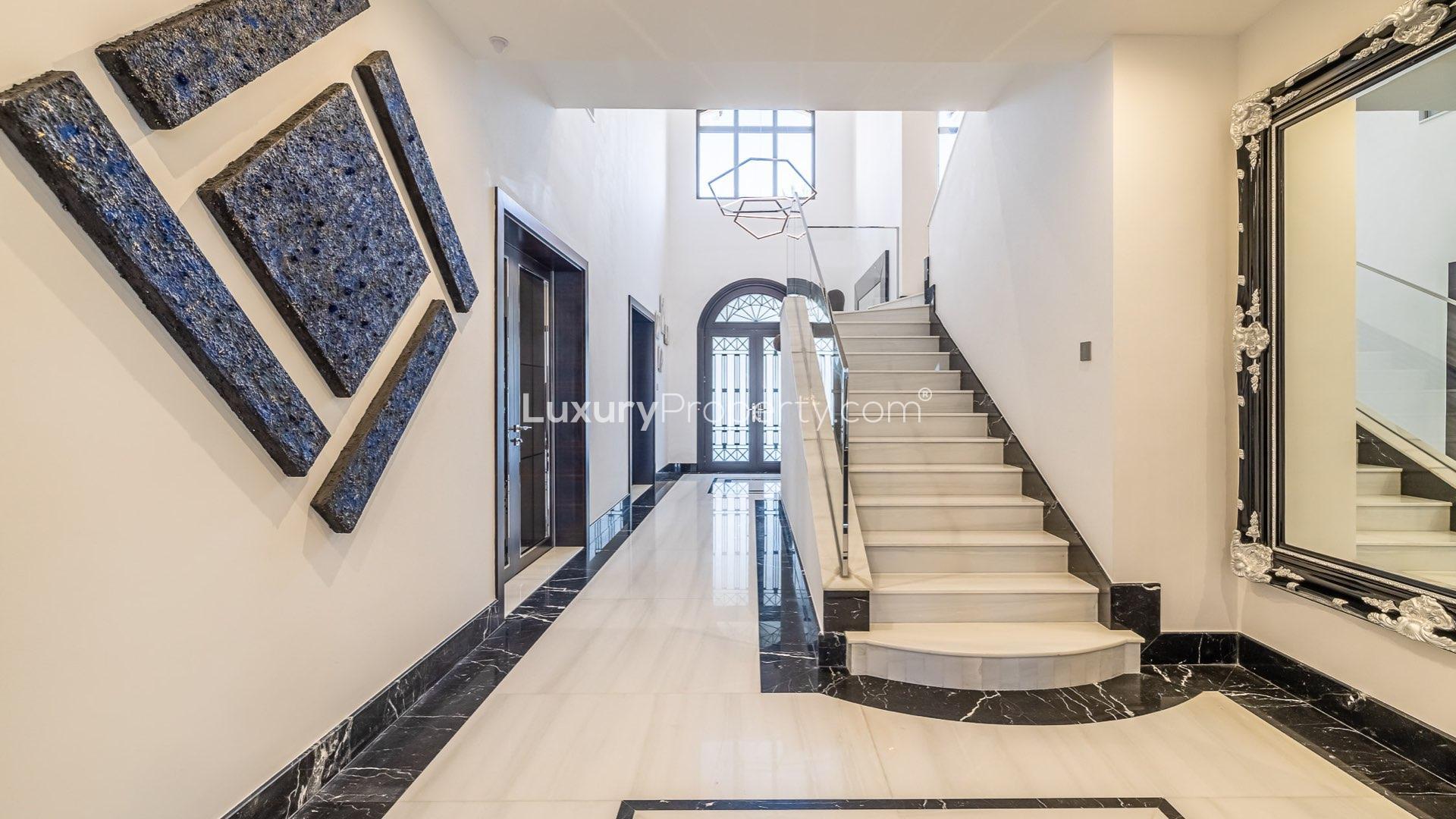 Luxurious open-plan kitchen and living area in Palm Jumeirah villa, marble finishes, modern design