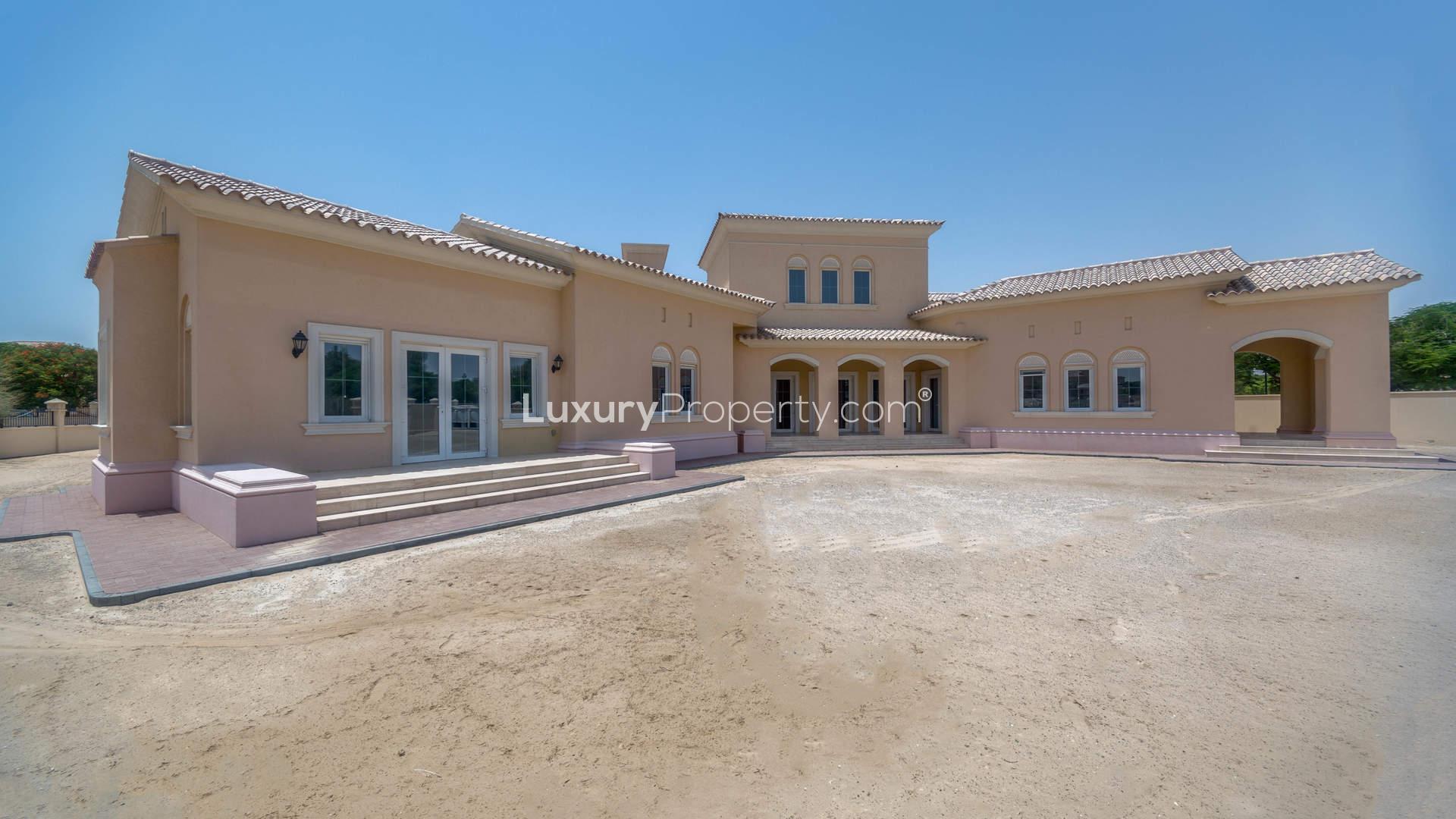 Spacious villa exterior with palm trees in Golf Homes, Arabian Ranches for sale