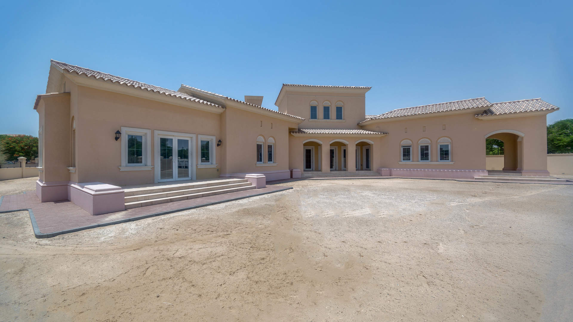 Spacious villa exterior with palm trees in Golf Homes, Arabian Ranches for sale