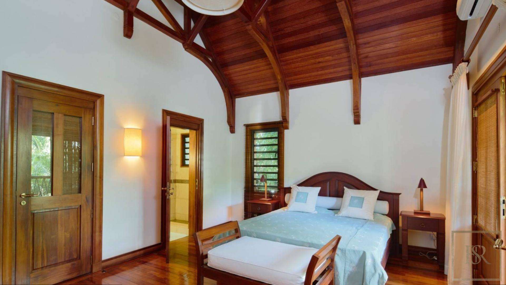 Luxurious bedroom in well-designed villa, Grand Bay, North Mauritius, with elegant wooden ceiling
