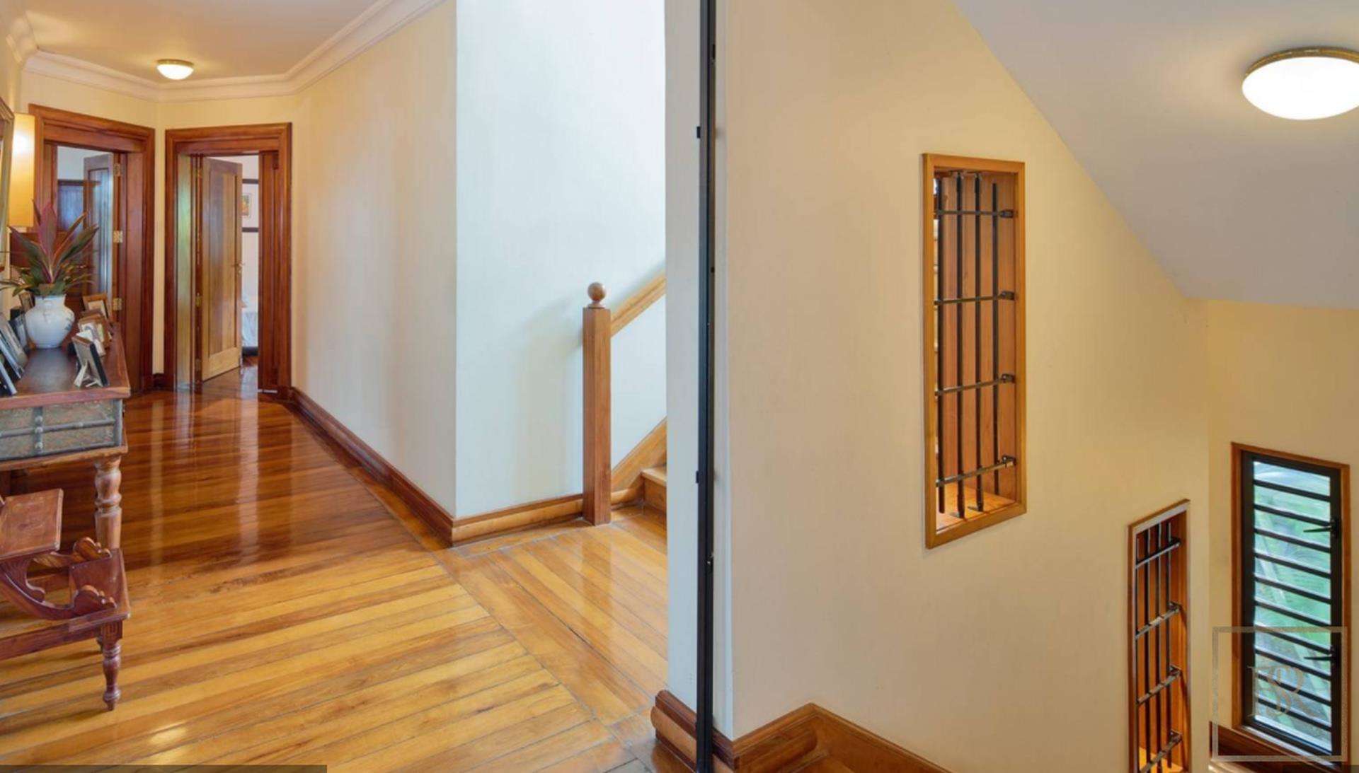 "Spacious bedroom with wooden accents in Grand Bay villa, North Mauritius, for sale.","Elegant wooden hallway in Grand Bay villa, North Mauritius, showcasing polished floors and decor.",Luxurious bedroom with wooden ceiling in Grand Bay villa, North Mauritius, for sale