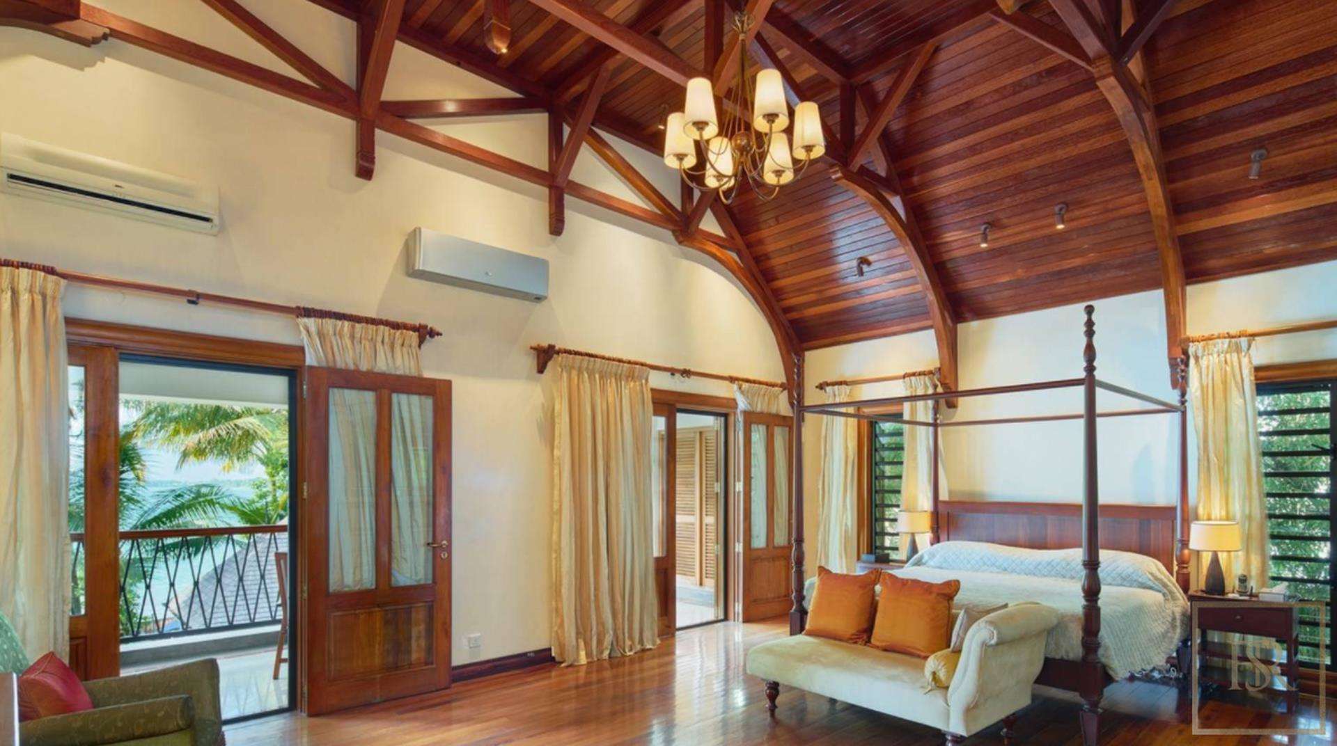 Spacious bedroom with wooden ceiling in Grand Bay oceanfront villa, Mauritius