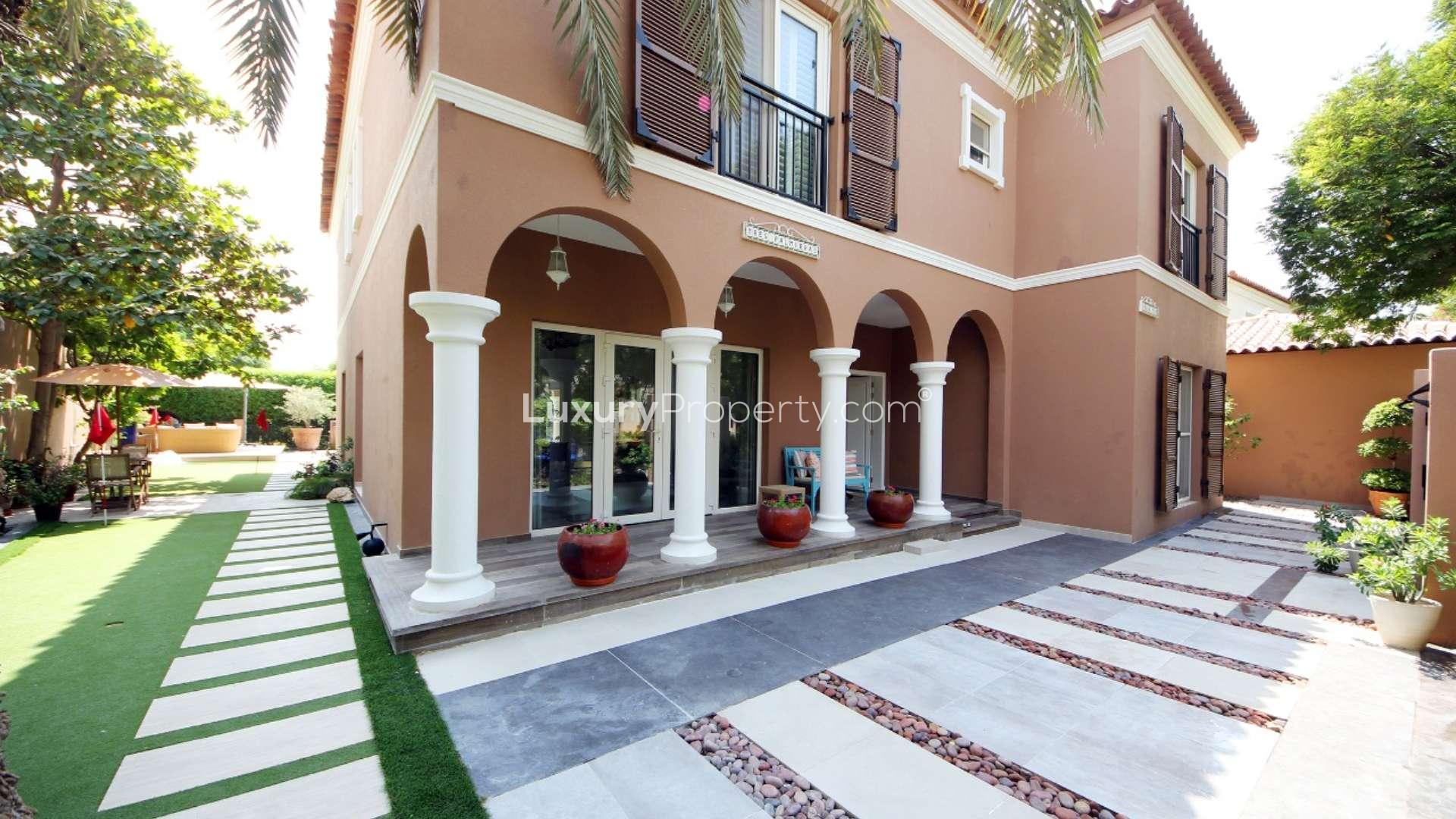 Outdoor patio with seating and pool at 5-bedroom villa in Green Community East, Dubai