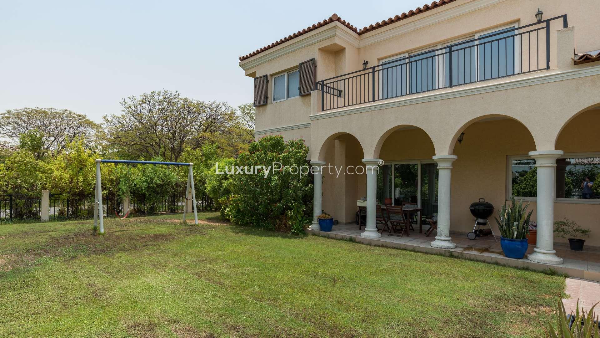 5-bedroom villa exterior in Green Community West, Dubai, with lush greenery and driveway