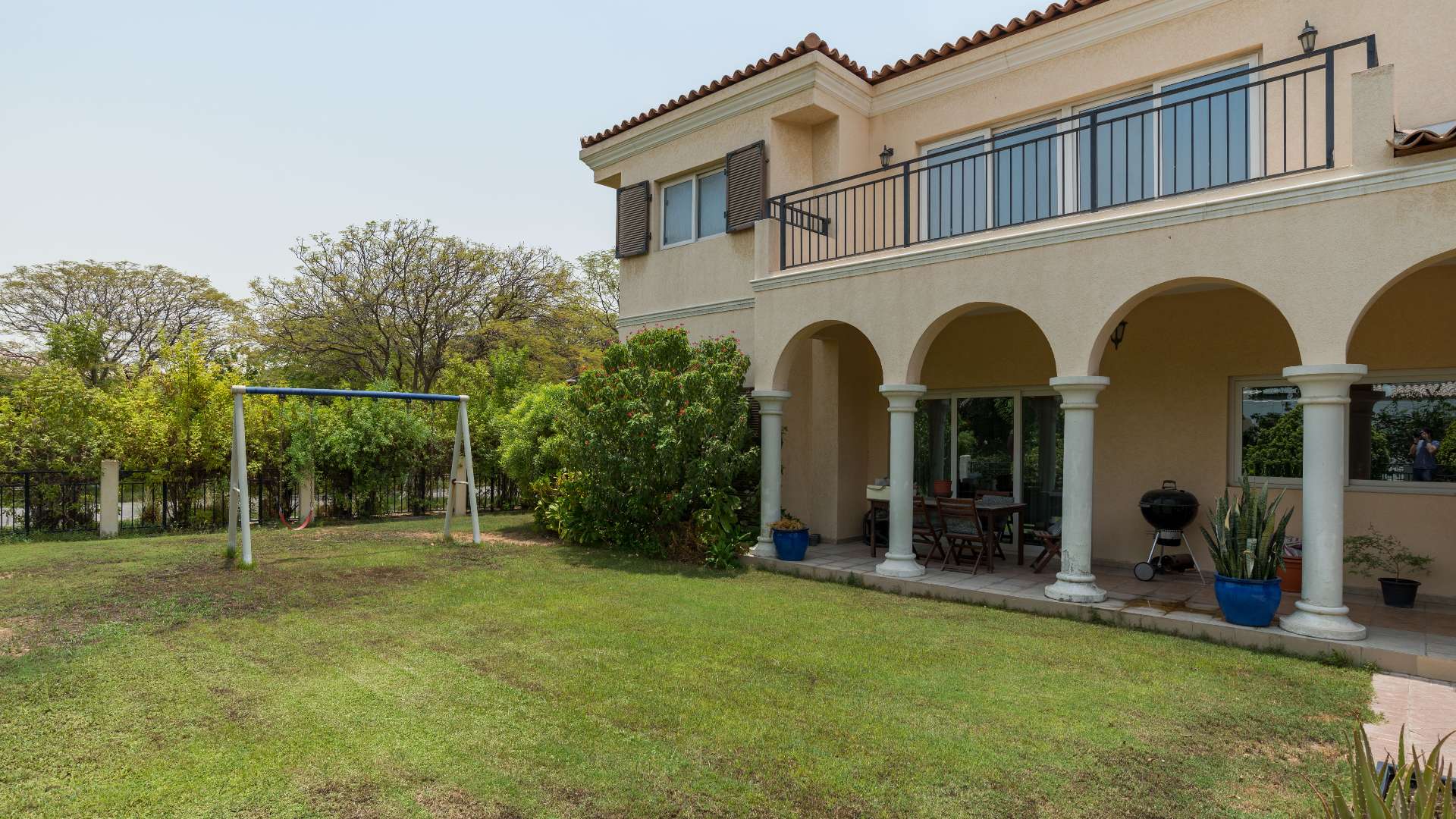 5-bedroom villa exterior in Green Community West, Dubai, with lush greenery and driveway