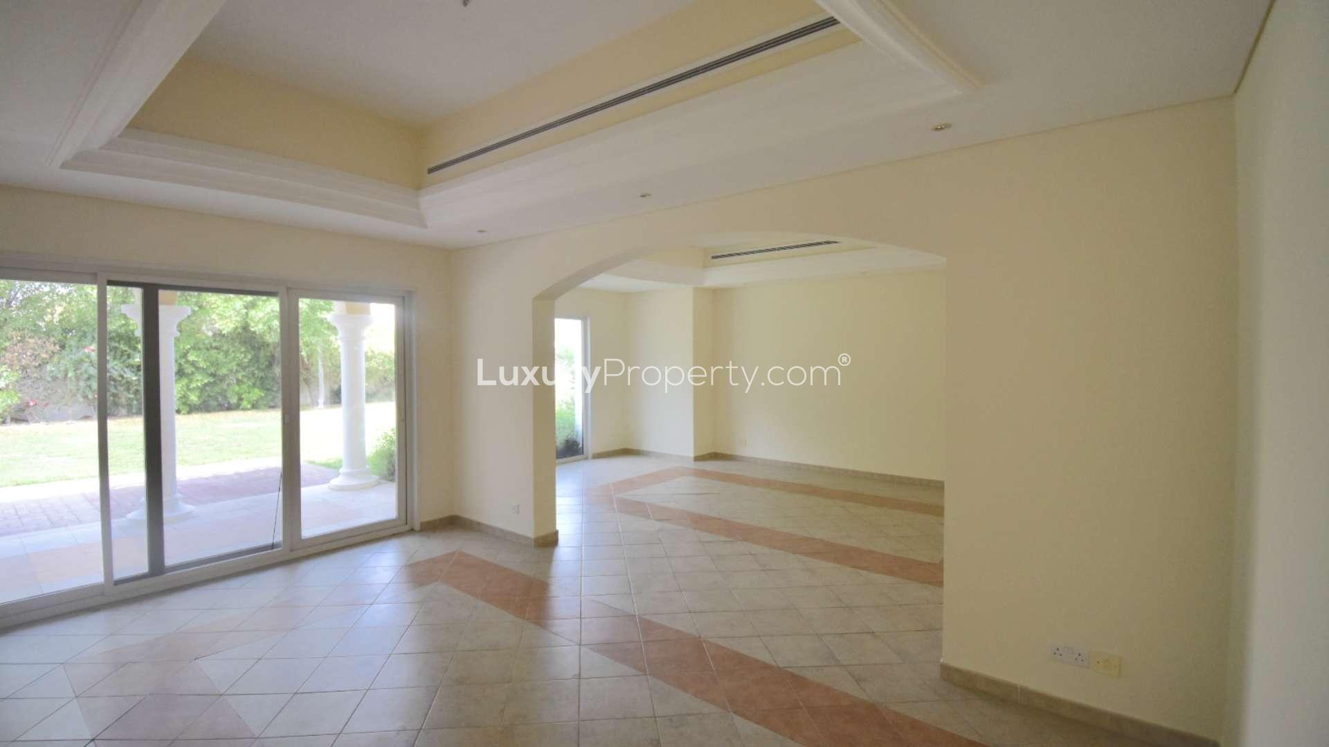 Spacious villa interior with large windows and garden view in Green Community West