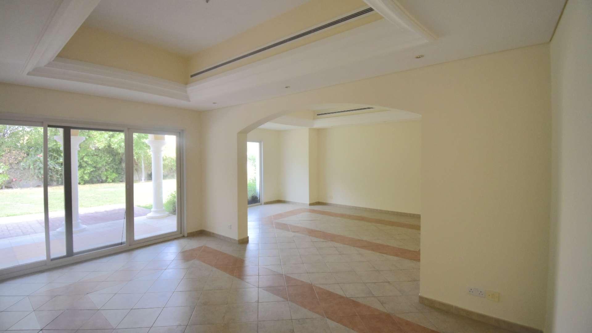Spacious villa interior with large windows and garden view in Green Community West