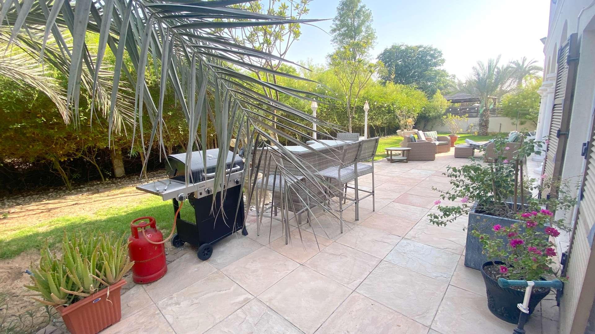 "Spacious villa patio with outdoor seating in Green Community West, ideal family home for sale.",Outdoor patio with barbecue and seating area in Green Community West villa for sale