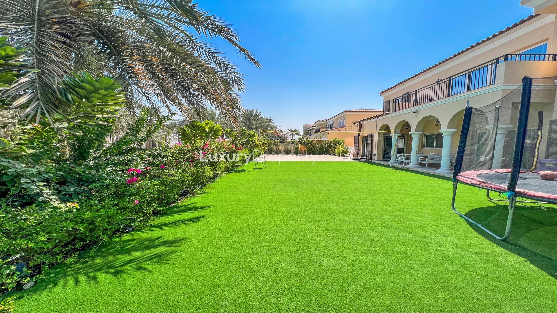 Expansive villa exterior with lush garden in Green Community West, 5-bedroom family home
