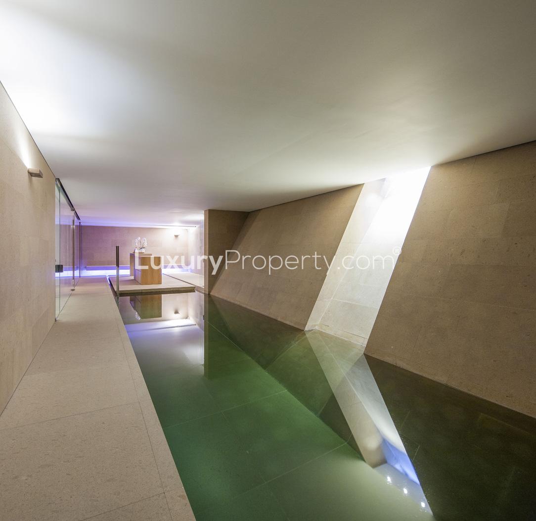 Luxurious living room in Hampstead Village villa with modern decor and large windows