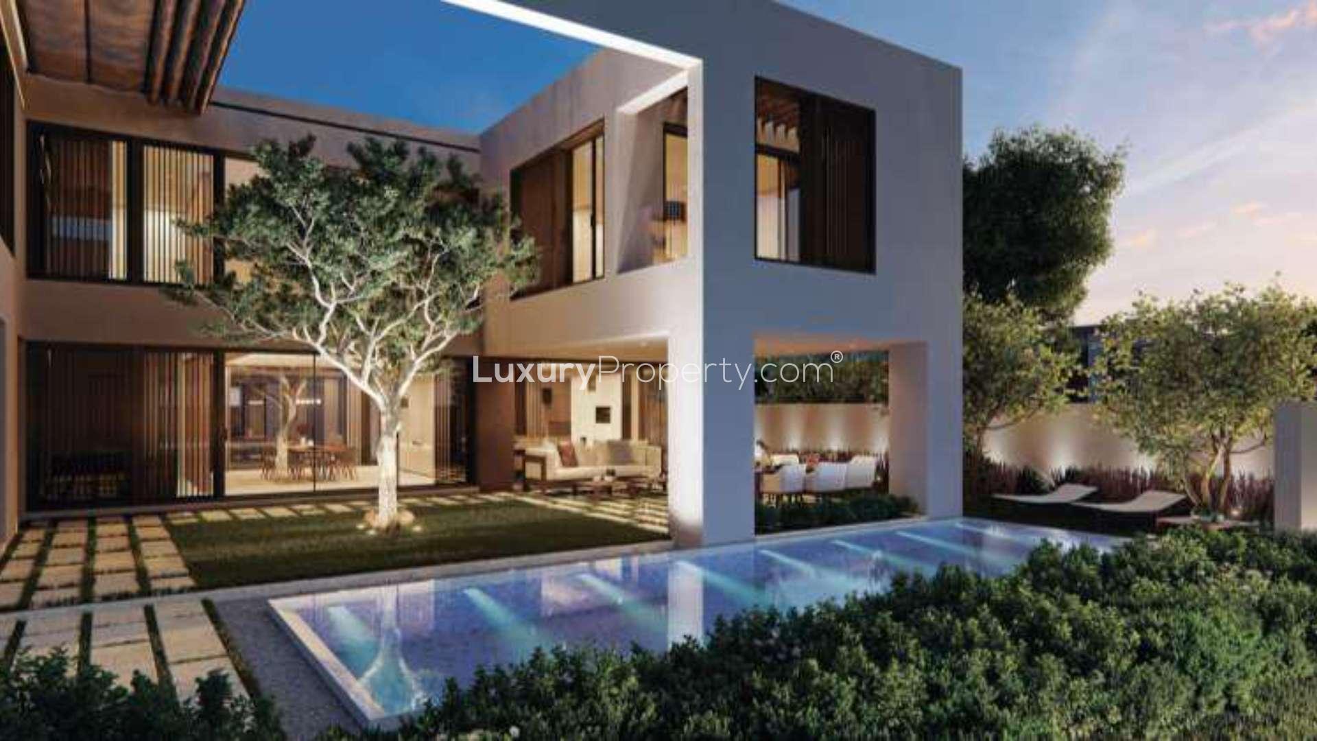 Luxurious villa with pool and lake view in Harmony II, Tilal Al Ghaf, at sunset