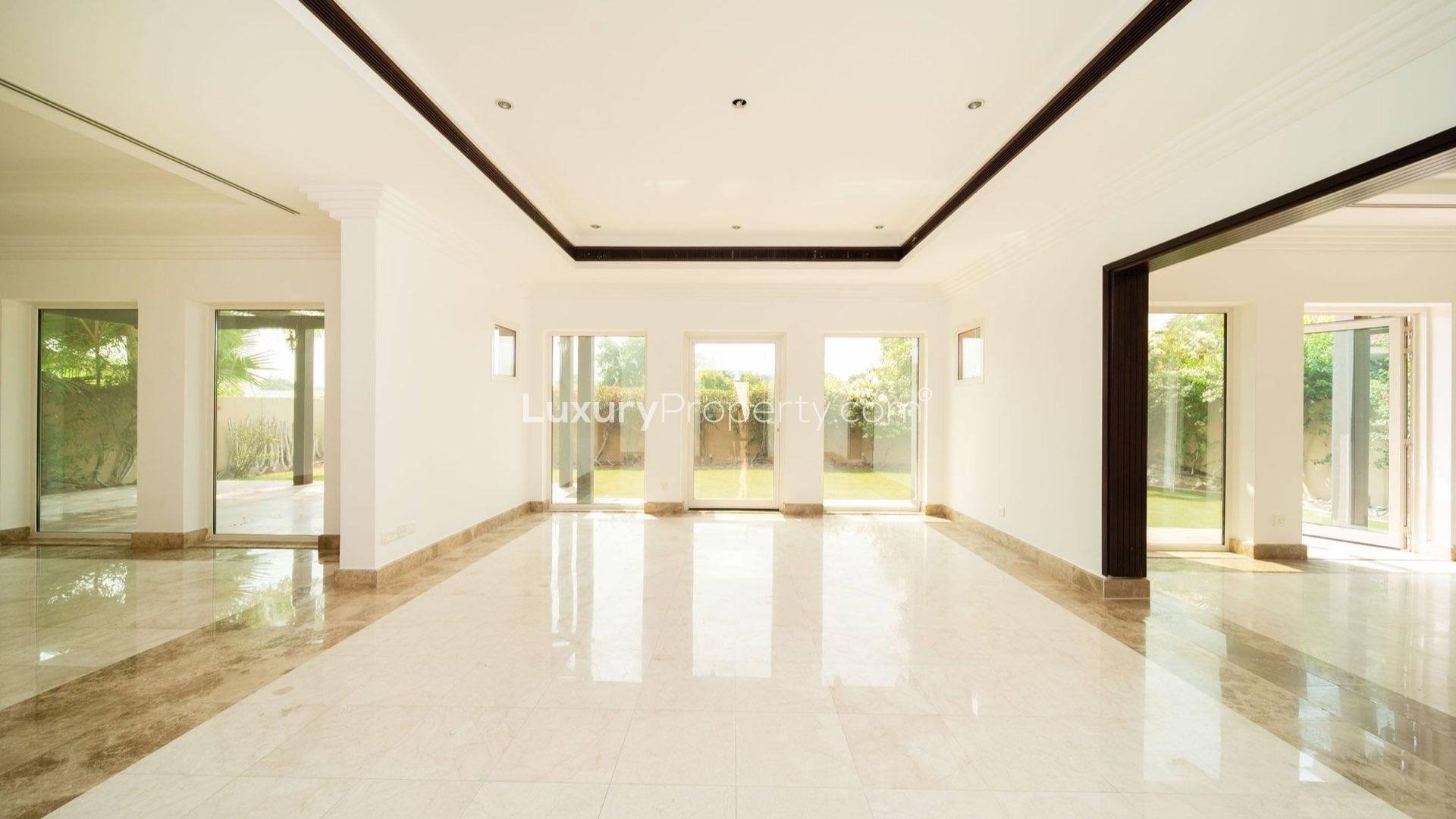 "Spacious villa with landscaped garden for sale in Hattan, The Lakes, featuring modern architecture.",Bright, spacious living area with garden view in Hattan villa, The Lakes