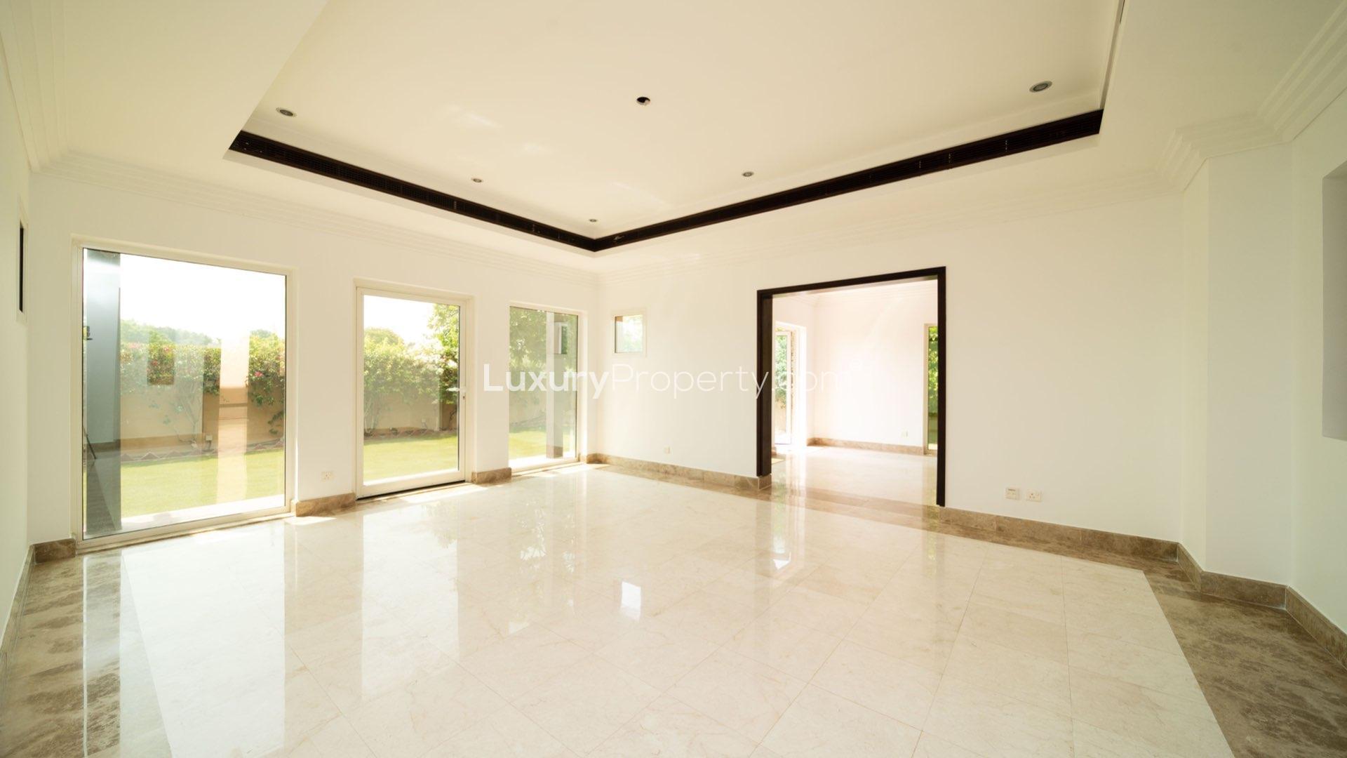 Bright living room with marble flooring in Hattan villa, The Lakes community